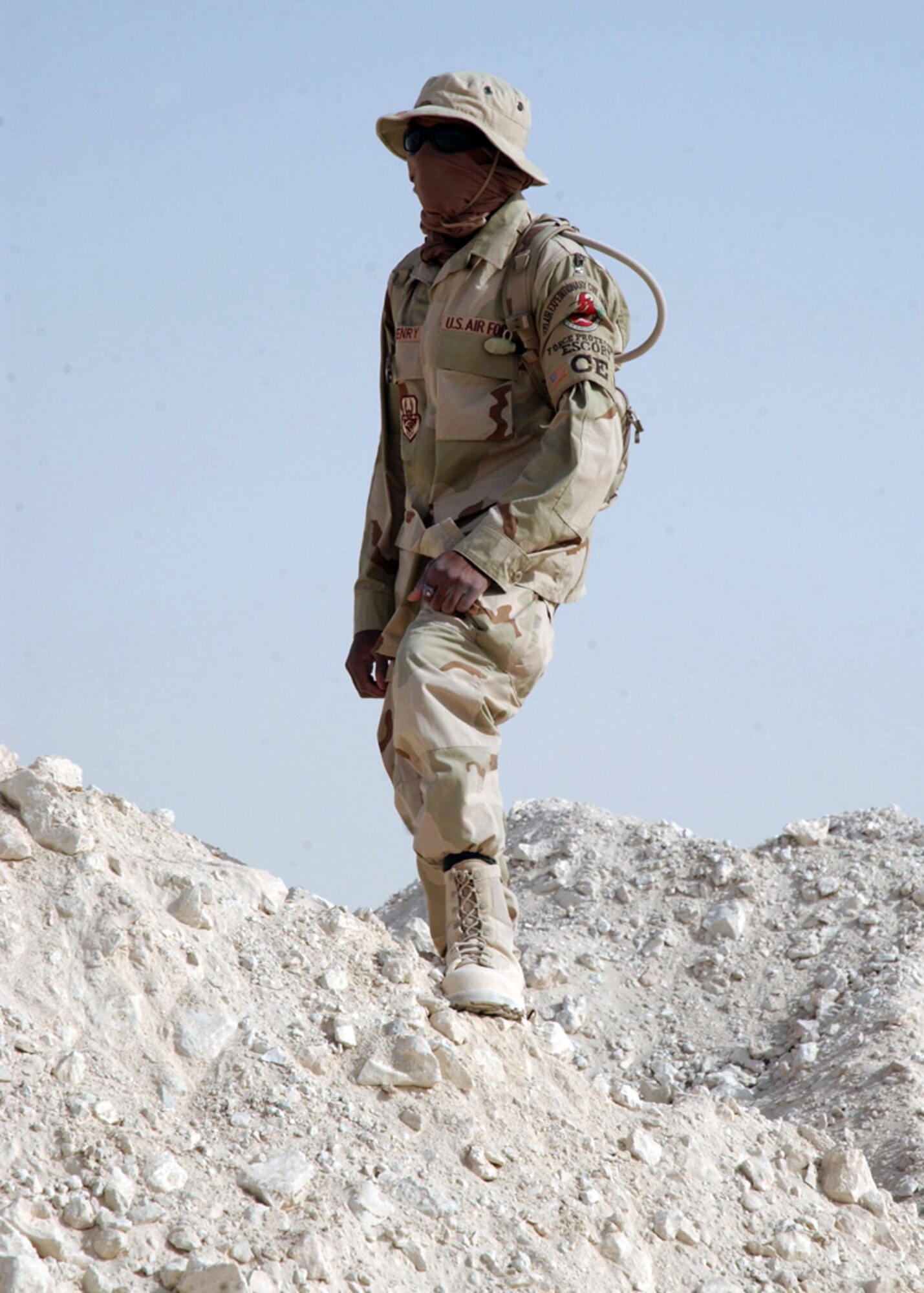 SOUTHWEST ASIA (AFPN) -- Airman 1st Class Christopher Henry watches third country national contractors build a new structure at a deployed location on Jan. 22. Airman Henry is a third country national escort with the 379th Expeditionary Civil Engineer Squadron, deployed from Langley Air Force Base, Va. (U.S. Air Force photo by Staff Sgt. Joshua Strang)