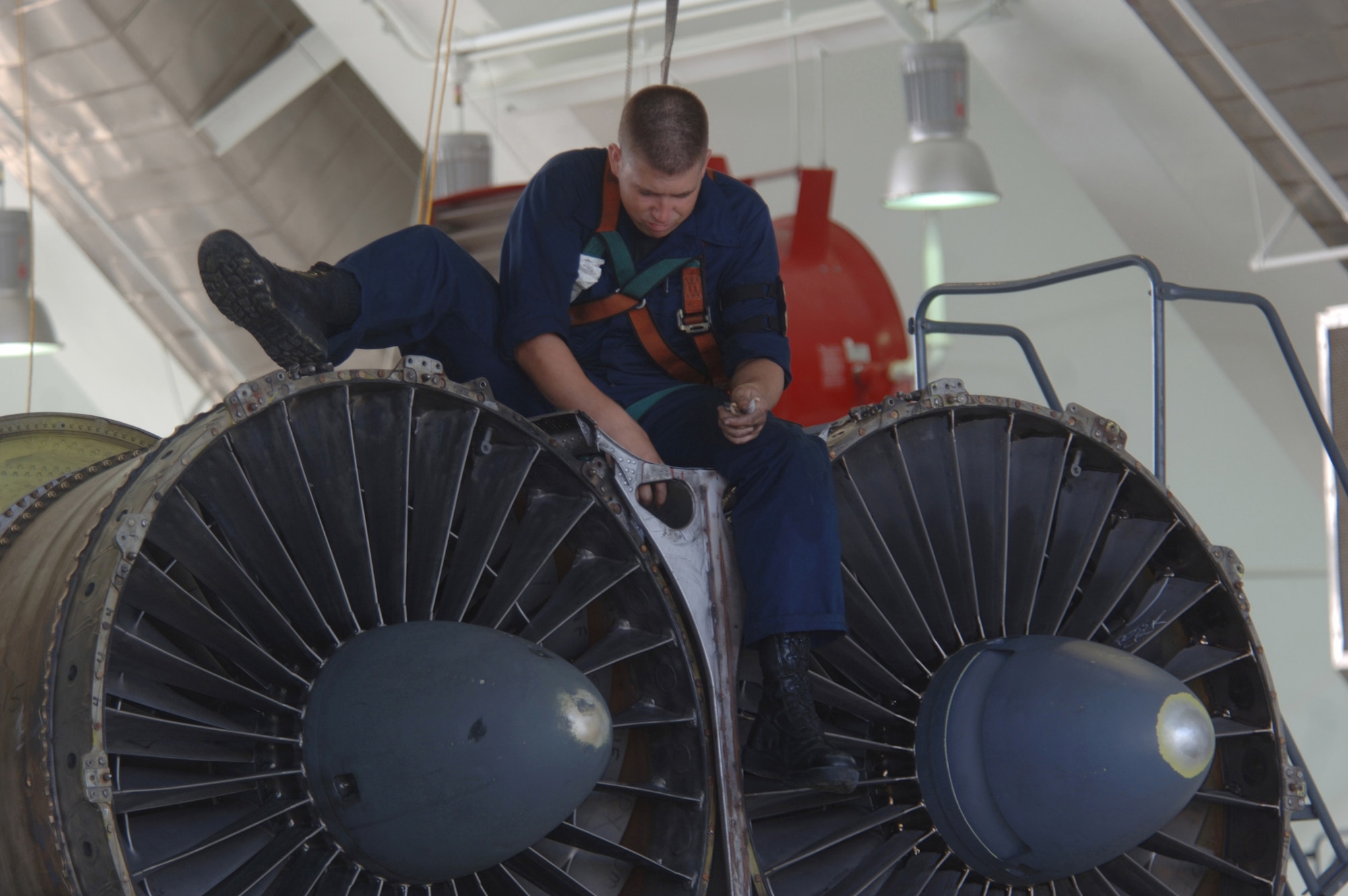 ANDERSEN AIR FORCE BASE, Guam (AFPN) -- Senior Airman Tommy Taylor inspects the engine of his B-52 Stratofortress aircraft during phase maintenance at Hangar 1 here.  Airman Taylor is with the 2nd Maintenance Squadron at Barksdale Air Force Base, La. The B-52s come here from a forward-deployed location and go into phase maintenance after 300 flying hours. The $34-million hangar is the newest in the Air Force and can house any type of Air Force aircraft. (U.S. Air Force photo by Master Sgt. Val Gempis)