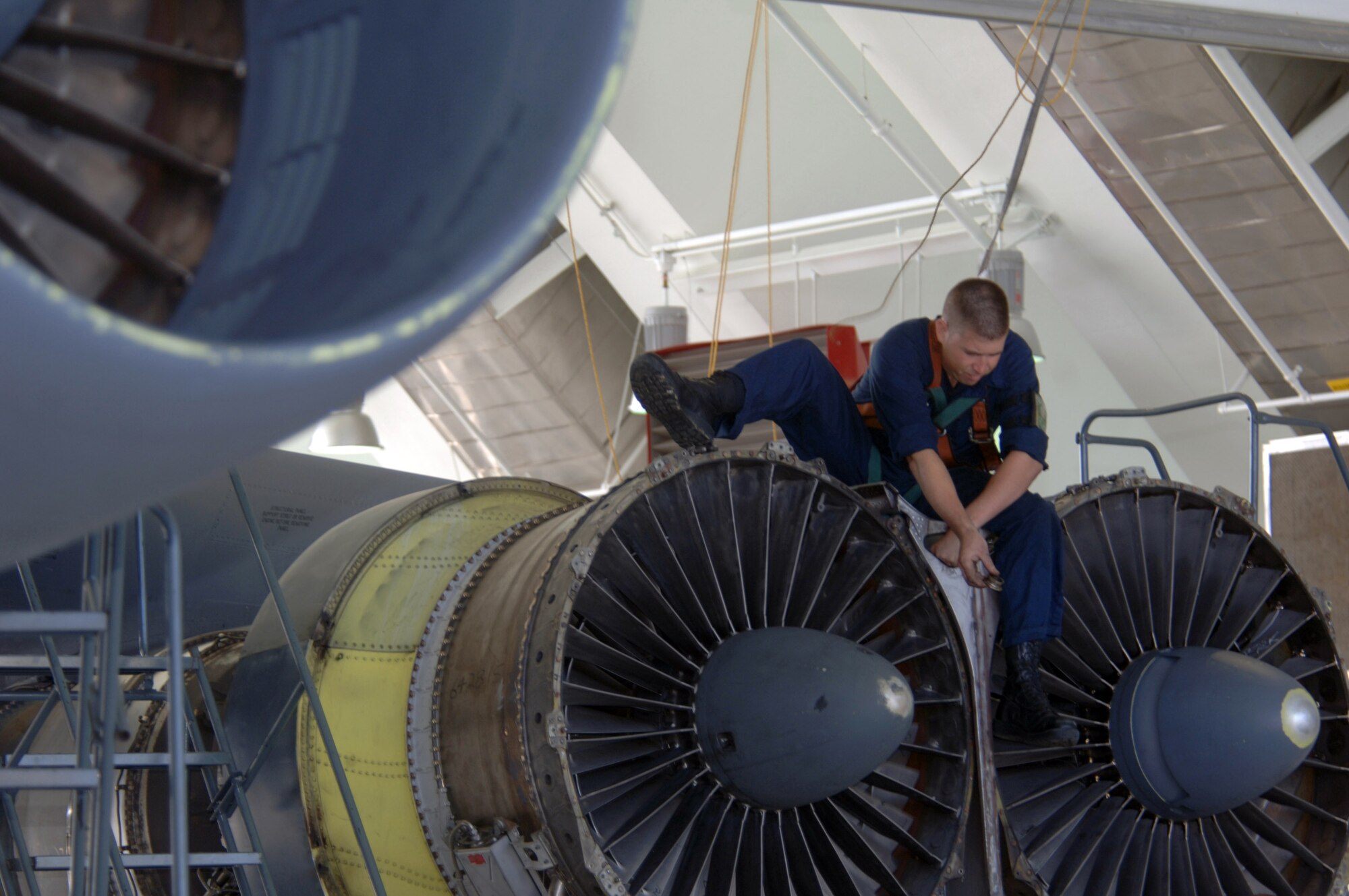 ANDERSEN AIR FORCE BASE, Guam (AFPN) -- Senior Airman Tommy Taylor inspects the engine of his B-52 Stratofortress aircraft during phase maintenance at Hangar 1 here.  Airman Taylor is with the 2nd Maintenance Squadron at Barksdale Air Force Base, La. The B-52s come here from a forward-deployed location and go into phase maintenance after 300 flying hours. The $34-million hangar is the newest in the Air Force and can house any type of Air Force aircraft. (U.S. Air Force photo by Master Sgt. Val Gempis)