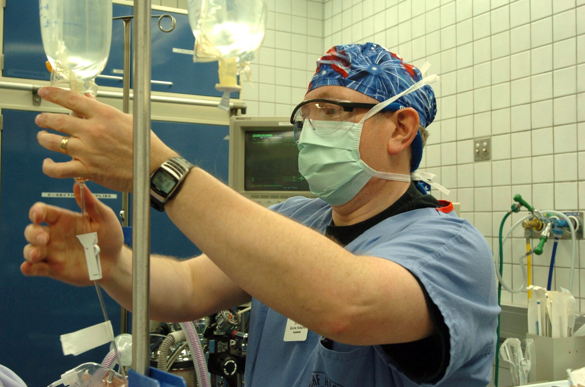 SPANGDAHLEM AIR BASE, Germany (AFPN) - Lt. Col. Kevin Scharff injects medication into an IV during a scheduled Cesarean section at the Bitburg Annex Hospital Jan. 18. National Nurse Anesthetist Week kicked off Jan. 22 and goes through Jan. 28. The week honors Certified Registered Nurse Anesthetists and educates people on the importance of their work. Nurse anesthetists have been working with surgeons, dentists and podiatrists for nearly 150 years to deliver safe anesthetic care. The Bitburg hospital has three nurse anesthetists on staff who provide care to about 900 servicemembers and their families each year. The team also augments Landstuhl Army Regional Medical Center in support of Operation Iraqi Freedom. Colonel Scharff is the 52nd Medical Operations Squadron chief nurse anesthetist. (U.S. Air Force photo by Senior Airman Eydie Sakura)