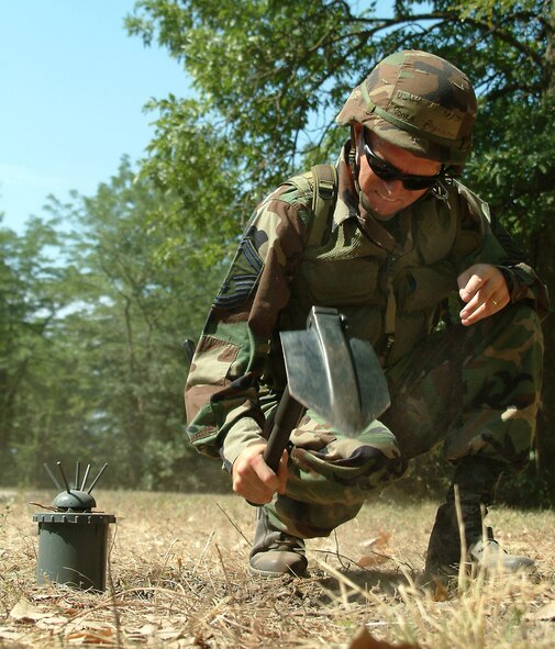 Senior Master Sgt. Roger Proffitt, 442nd Civil Engineer Squadron, places an inert mine training aid during a training exercise at Whiteman AFB. The 442nd CES is part of the 442nd Fighter Wing, an Air Force Reserve unit based at Whiteman Air Force Base, Mo. (Photo by Master Sgt. Bill Huntington)