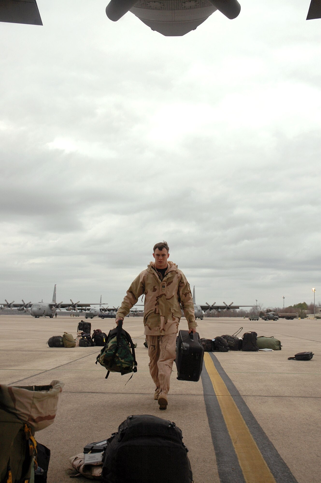 LITTLE ROCK AIR FORCE BASE, Ark. (AFPN) -- Capt. Mark Yarian carries his gear to the back of a C-130 Hercules before departing for Southwest Asia. Two C-130s and 24 Airmen from the 463rd Airlift Group deployed Jan. 20 for 120 days. Captain Yarian is a pilot with the 61st Airlift Squadron. (U.S. Air Force photo by 1st Lt. Jon Quinlan) 