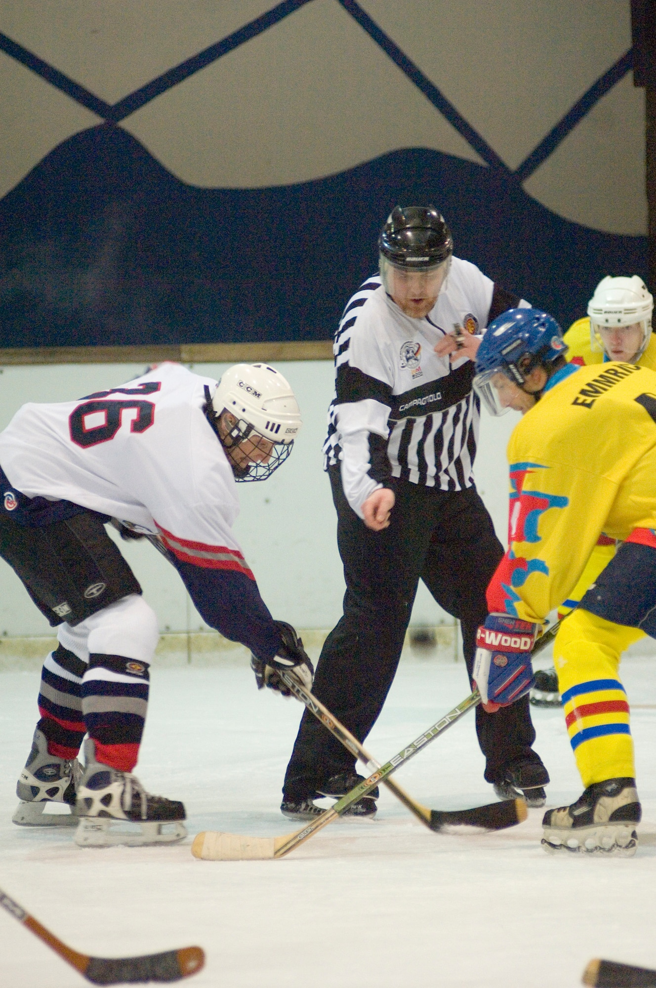 EPPELHEIM, Germany (AFPN) -- The referee drops the puck to restart play as Capt. Kris Uber (left) faces off against a player from the Eppelheim Hawks. The KMC Eagles won 6-4. The Kaiserslautern Military Community hockey team is made up of 30 players in different skill levels varying from semi-pro and college to players experiencing their first organized game. Captain Uber is with the 76th Airlift Squadron at Ramstein Air Base, Germany. (U.S. Air Force photo by Master Sgt. John E. Lasky)