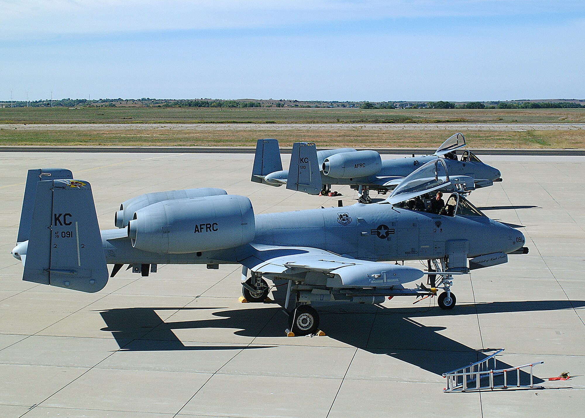 Two 442nd Fighter Wing A-10 Thunderbolt IIs parked on the ramp at Salina Airport, Kan.  The aircraft operated from Salina for a Combat Search and Rescue Exercise over nearby Smoky Hill Range. (Photo by Master Sgt. Bill Huntignton)