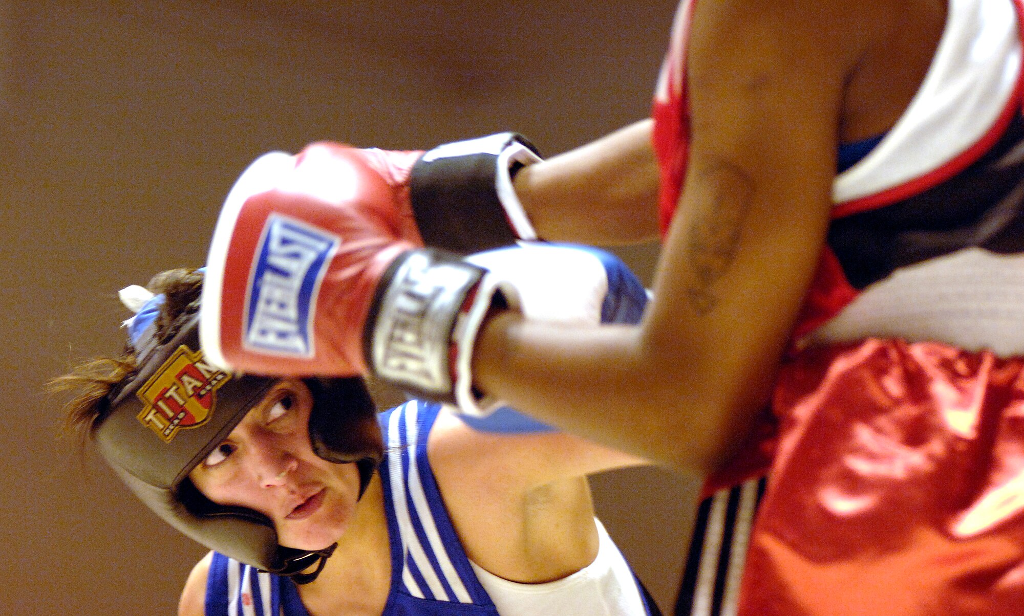 SAN ANTONIO (AFPN) -- Celsa Reyes connects with a body shot jab to Emma Atolagbe. Reyes won by decision Jan. 20. Reyes is from F.E. Warren Air Force Base, Wyo., and Atolagbe is from Langley AFB, Va. Both will represent the Air Force at the Armed Forces Boxing Tournament at Fort Huachuca, Ariz., Feb. 6 to 11. (U.S. Air Force photo by Tech. Sgt. Larry A. Simmons) 