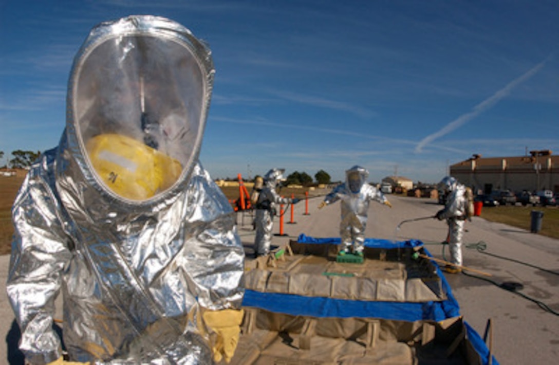U.S. Air Force Senior Airman Roy Heron III waits for fellow firefighters to process through a decontamination line during an emergency management exercise at MacDill Air Force Base, Fla., on Jan. 18, 2006. Heron is a firefighter attached to the 6th Civil Engineering Squadron. 