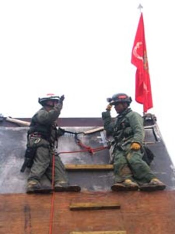 INDIAN HEAD, Md. - Chief Warrant Officer 3 Ramon Perez (right) administers the oath of reenlistment to Sgt. Gary D. Garcia atop a 'pile' at the Raymond M. Downey Sr. Training Facility Feb. 24.  The 'pile' is used by the Technical Rescue platoon Marines at the Chemical Biological Incident Response Force (CBIRF) to help them train for extricating casualties from a collapsed structure.  According to Garcia, leaving the Marine Corps would have been like "cheating the Marine Corps.  I've learned so much that I can pass on to junior Marines," said the San Angelo, Texas native.