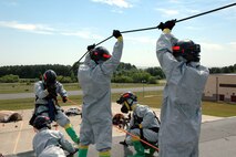 PATUXENT RIVER NAS--Technical Rescue personnel with the Chemical Biological Incident Response Force (CBIRF) secure a line as they prepare to rescue a victim that is trapped more than 40 feet off the ground during a training evolution May 24.  The exercise challenged the personnel to execute their mission with the additional strain of the summer heat, thereby strengthening the idea that top physical conditioning is paramount.