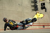 PATUXENT RIVER NAS--Lance Cpl. Jeremy F. Spier, a technical rescue technician with the Chemical Biological Incident Response Force (CBIRF), looks skyward after "picking off" a victim during a training evolution May 24.  During the mission Spier, of Lindale, Texas, moved the victim from the line he was suspended from to his own.  According to the 26-year-old technician, top physical conditioning of the back and shoulders is key to the success of missions of this type.