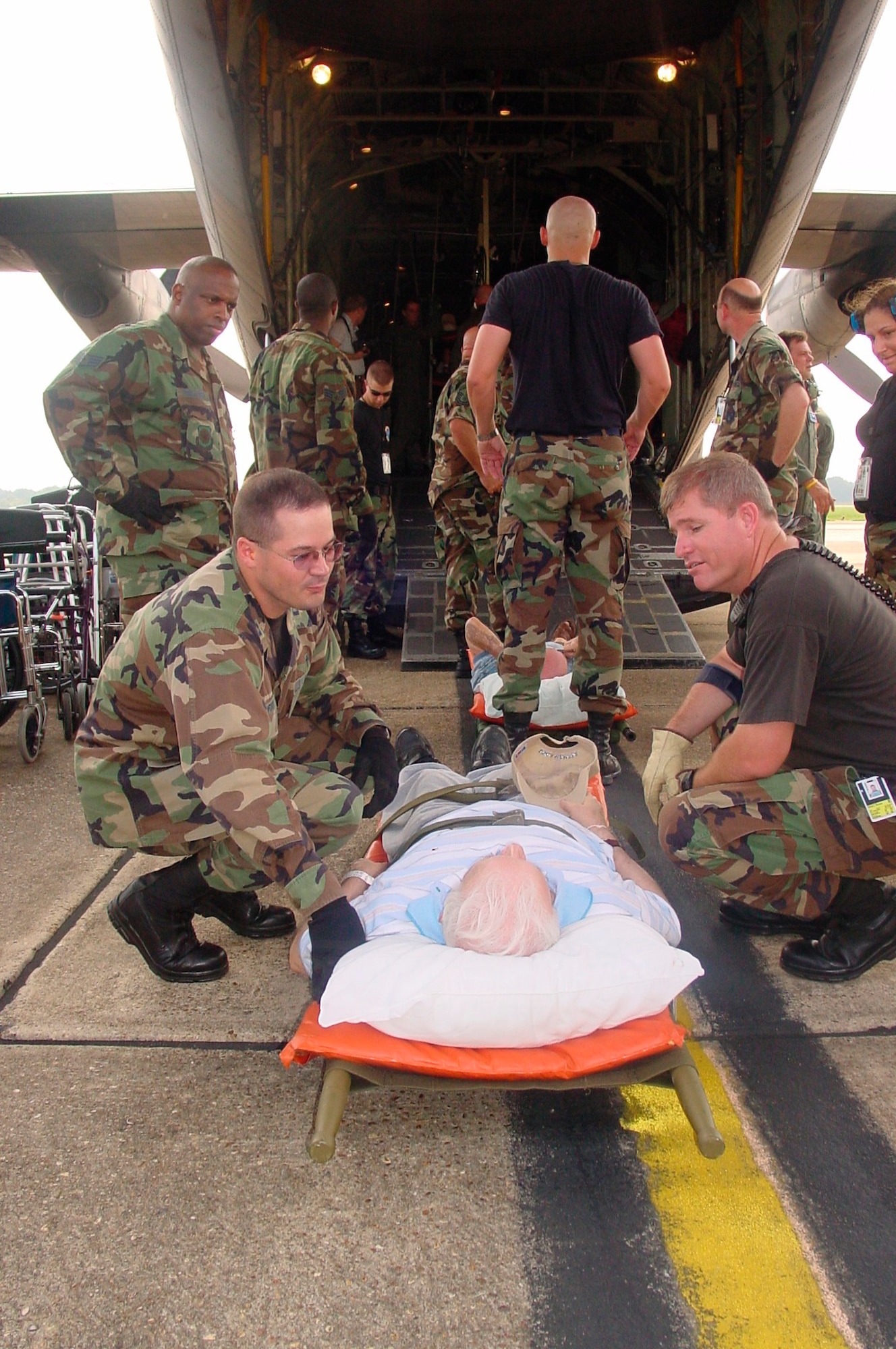 908th Airlift Wing Chaplain (Capt.) Jamie Danford provides comfort to a Gulf Coast  evacuee aboard a C-130 Hercules from the 357th Airlift Squadron.
Photo by Maj. Jerry Lobb, 908AW public affairs, Maxwell AFB, Ala.