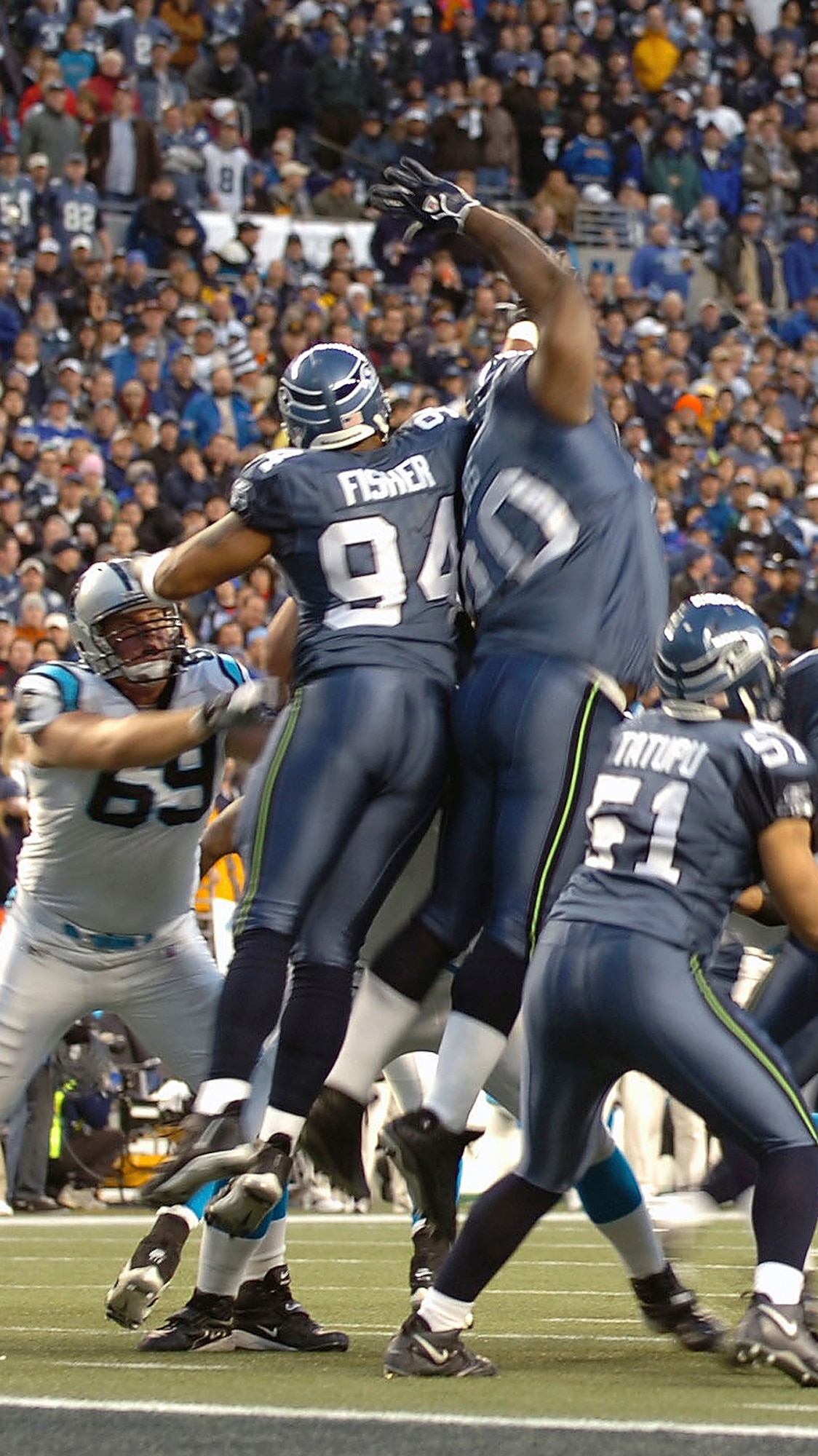 SEATTLE (AFPN) -- Defensive end (No. 94) Bryce Fisher, a captain in the Washington Air National Guard, gets airborne while trying to block a Carolina Panthers' extra-point kick during the Seattle Seahawks' 34-14 victory over the Carolina Panthers in Seattle on Jan. 22. The Seahawks clinched the National Football Conference title, are playing in Super Bowl XL on Feb. 5. (National Guard Bureau photo by Army Sgt. Jim Greenhill)
