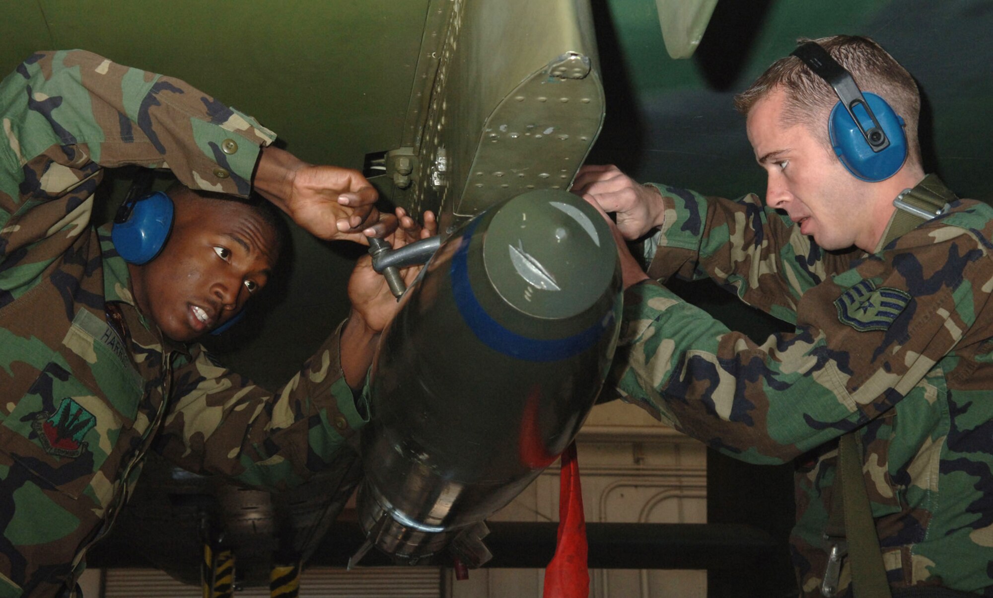 DAVIS-MONTHAN AIR FORCE BASE, Ariz. -- Staff Sgt. Paul Retherford and Senior Airman Samuel Harris tighten the sway braces and secure a 500-pound bomb as part of a load crew competition. Both Airmen are assigned to the 355th Aircraft Maintenance Squadron. (U.S. Air Force photo by Staff Sgt. Lanie McNeal)
