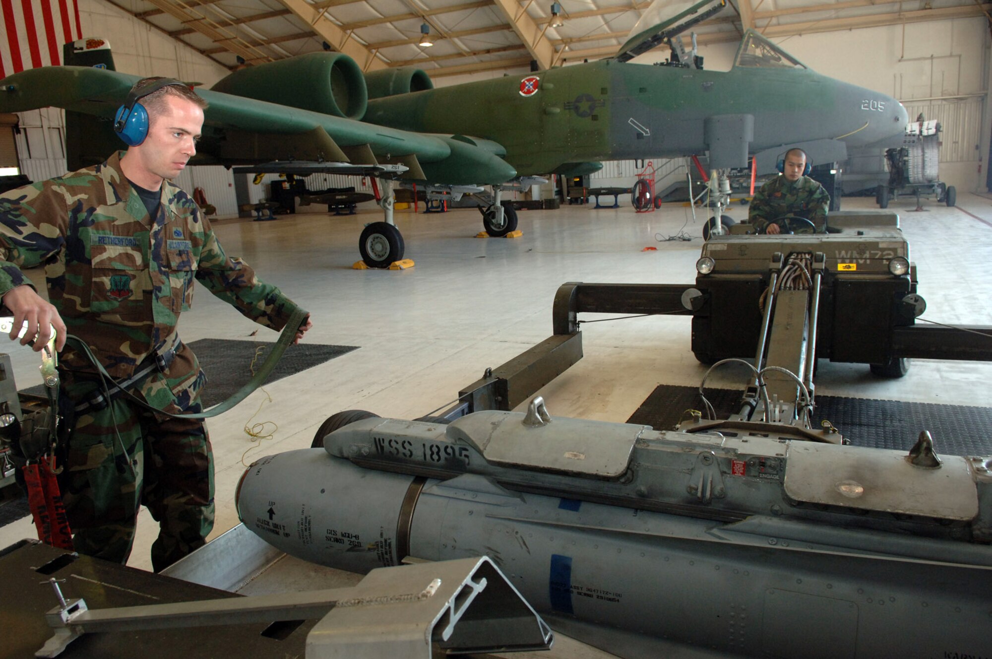 DAVIS-MONTHAN AIR FORCE BASE, Ariz. (AFPN) -- Staff Sgt. Paul Retherford and Airman 1st Class Bahl Delos-Santos prepare the bomb-lift truck as they get ready to transport a Maverick missile to an awaiting A-10 Thunderbolt as part of a load crew competition here. The Airmen are assigned to the 355th Aircraft Maintenance Squadron, which is comprised of the 354th, 357th and 358th Aircraft Maintenance Units. The 357th AMU placed first and completed the load in 38 minutes and 44 seconds.  (U.S. Air Force photo by Staff Sgt. Lanie McNeal)