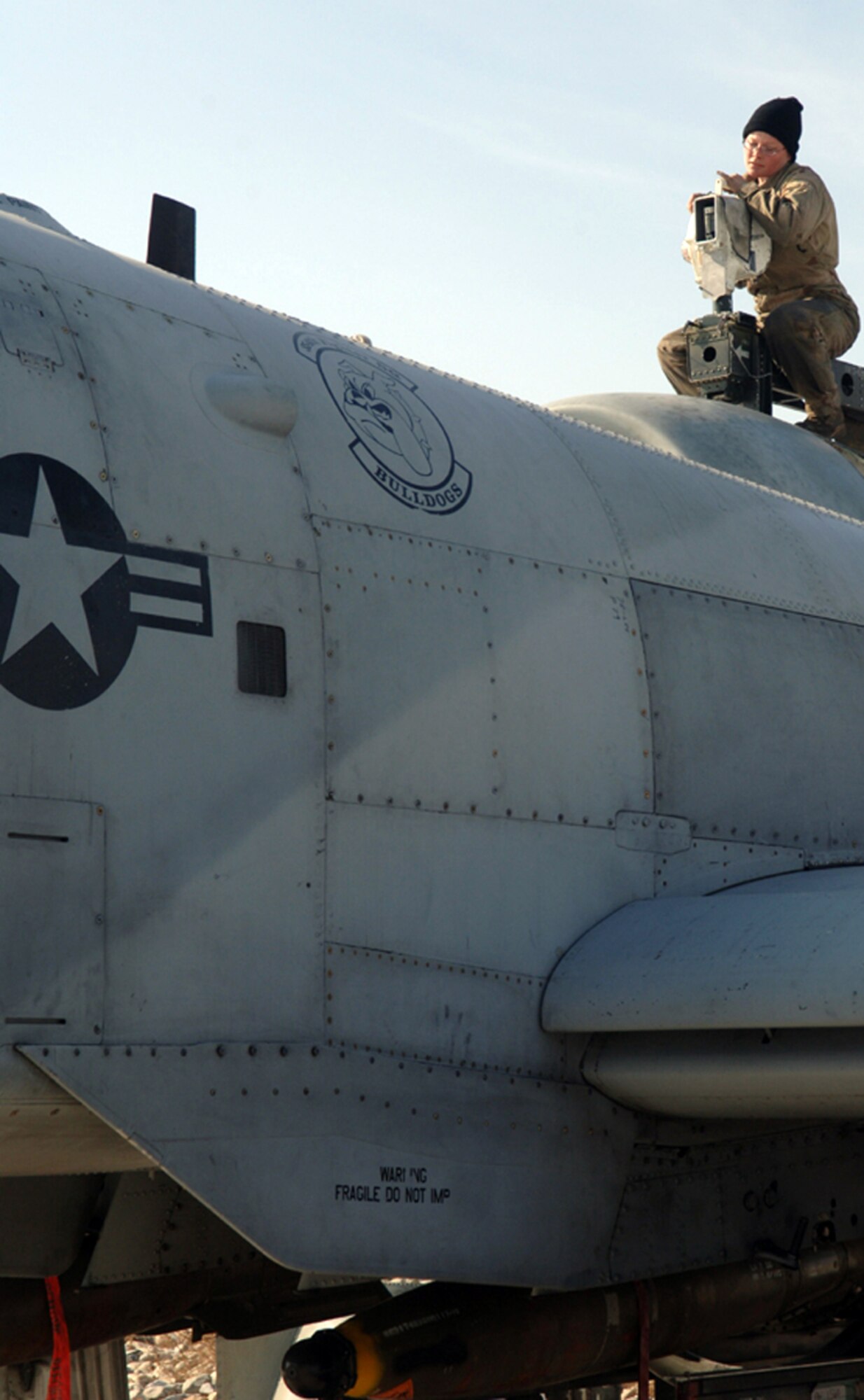 BAGRAM AIR BASE, Afghanistan (AFPN) -- Staff Sgt. Julie Jewett cranks an engine hoist atop an A-10 Thunderbolt II. Sergeant Jewett is an aerospace propulsion craftsman with the 455th Expeditionary Aircraft Maintenance Squadron. (U.S. Air Force photo by Staff Sgt. Jennifer L. Redente)