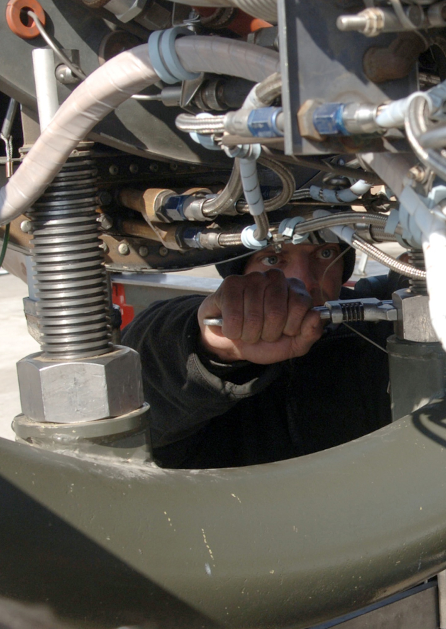 BAGRAM AIR BASE, Afghanistan (AFPN) -- Senior Airman Justin Mills makes adjustments with a wrench while preparing to replace an engine from an A-10 Thunderbolt II.  Airman Mills is an aerospace propulsion journeyman assigned to the 455th Expeditionary Aircraft Maintenance Squadron. (U.S. Air Force photo by Staff Sgt. Jennifer L. Redente)