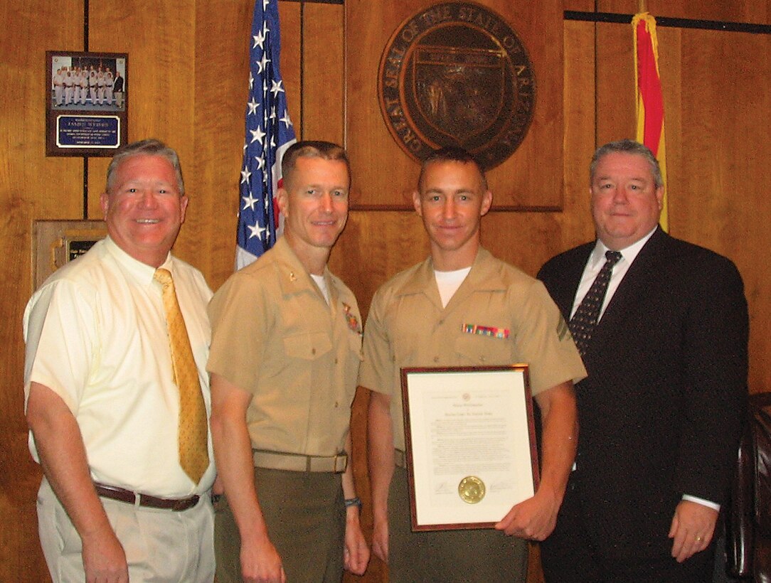 Rep. Russell Jones (left), Arizona House representative for District 24, Col. Ben Hancock, station commanding officer, Cpl. Michael Sandall, Headquarters and Headquarters Squadron Noncommissioned Officer of the Quarter, and Speaker James P. Weiers, Arizona Speaker of the House, pose for a picture after receiving the House Proclamation on May 25 on the Arizona House floor in Phoenix.