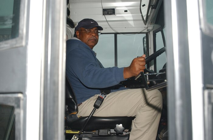 MARINE CORPS BASE CAMP LEJEUNE, N.C. - Lee C. Williams, a retired master sergeant who has been driving the base bus for more than 10 years, opens the door to allow passengers on.  The Base Bus is open to all military ID card holders. Photo by:  Lance Cpl. Adam Johnston