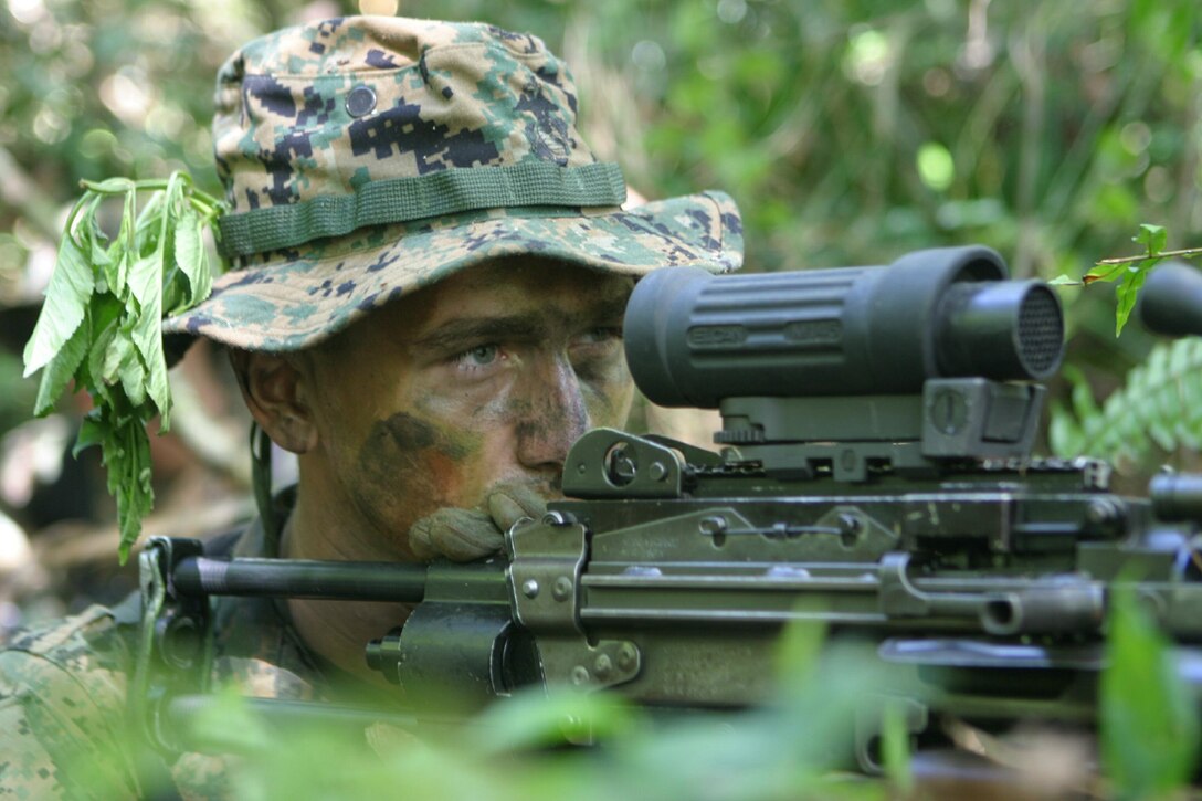 Lance Cpl. Adam Penn, a 20-year-old Joplin, Missouri native and squad automatic weapon gunner with 3rd Platoon, G Co., 2nd Battalion, 5th Marine Regiment, lies in wait for "enemy combatants" Jan. 26 during an ambush patrol conducted on the Naval Computer and Telecommunications Station, Guam.  The battalion is part of the Battalion Landing Team for the 31st Marine Expeditionary Unit, which is conducting its Marine Expeditionary Unit Exercise as part of its special operations capable qualification.