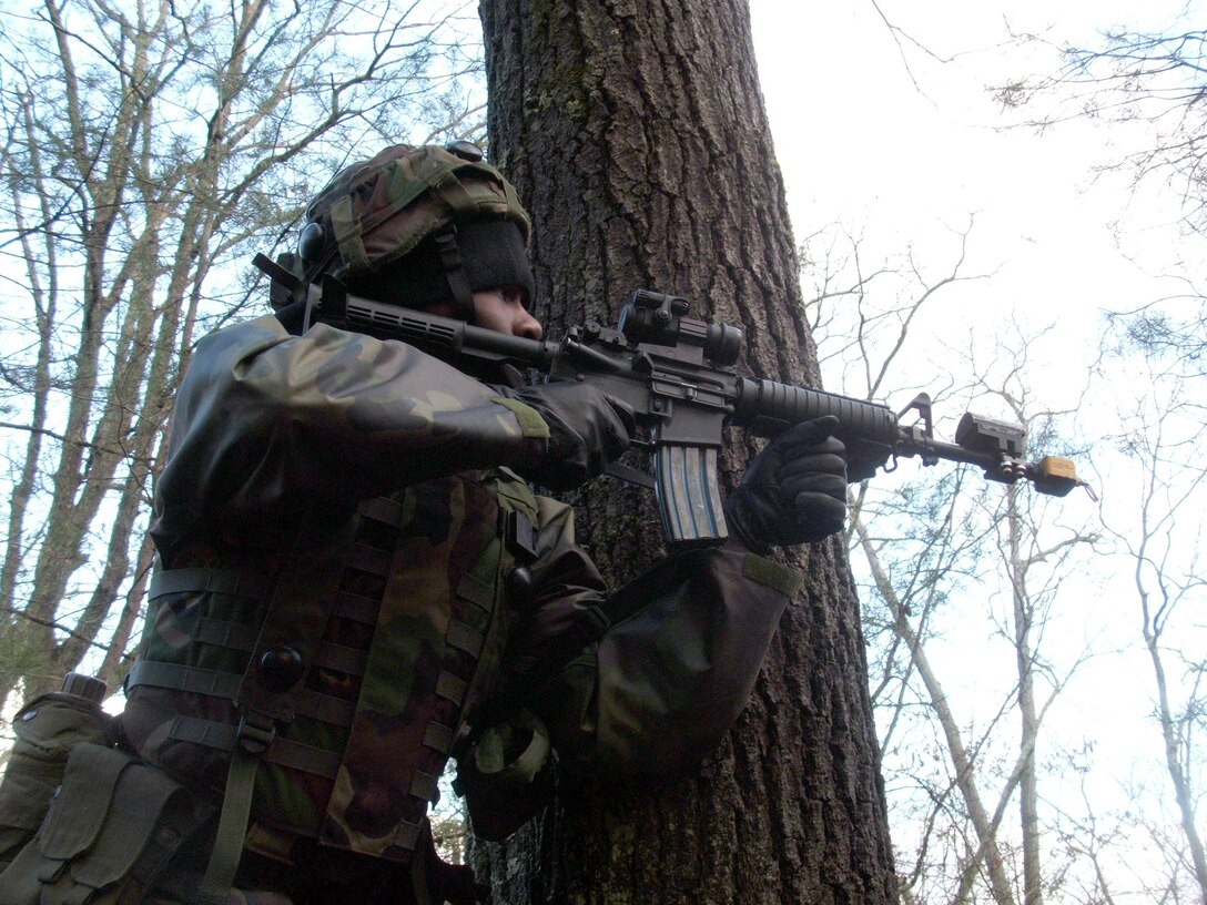 FORT DIX, N.J. (AFPN) -- Airman 1st Class Tarish Peterson takes up a position next to a tree while engaging "opposing forces" during a scenario for the Air Force Integrated Contingency Skills Training Course 06-1 here. She is a security forces Airman from the 22nd Security Forces Squadron at McConnell Air Force Base, Kansas. The training, taught and operated by the Air Mobility Warfare Center's 421st Combat Training Course, prepared more than 100 Airmen for upcoming deployments. (U.S. Air Force photo by Tech. Sgt. Scott T. Sturkol)