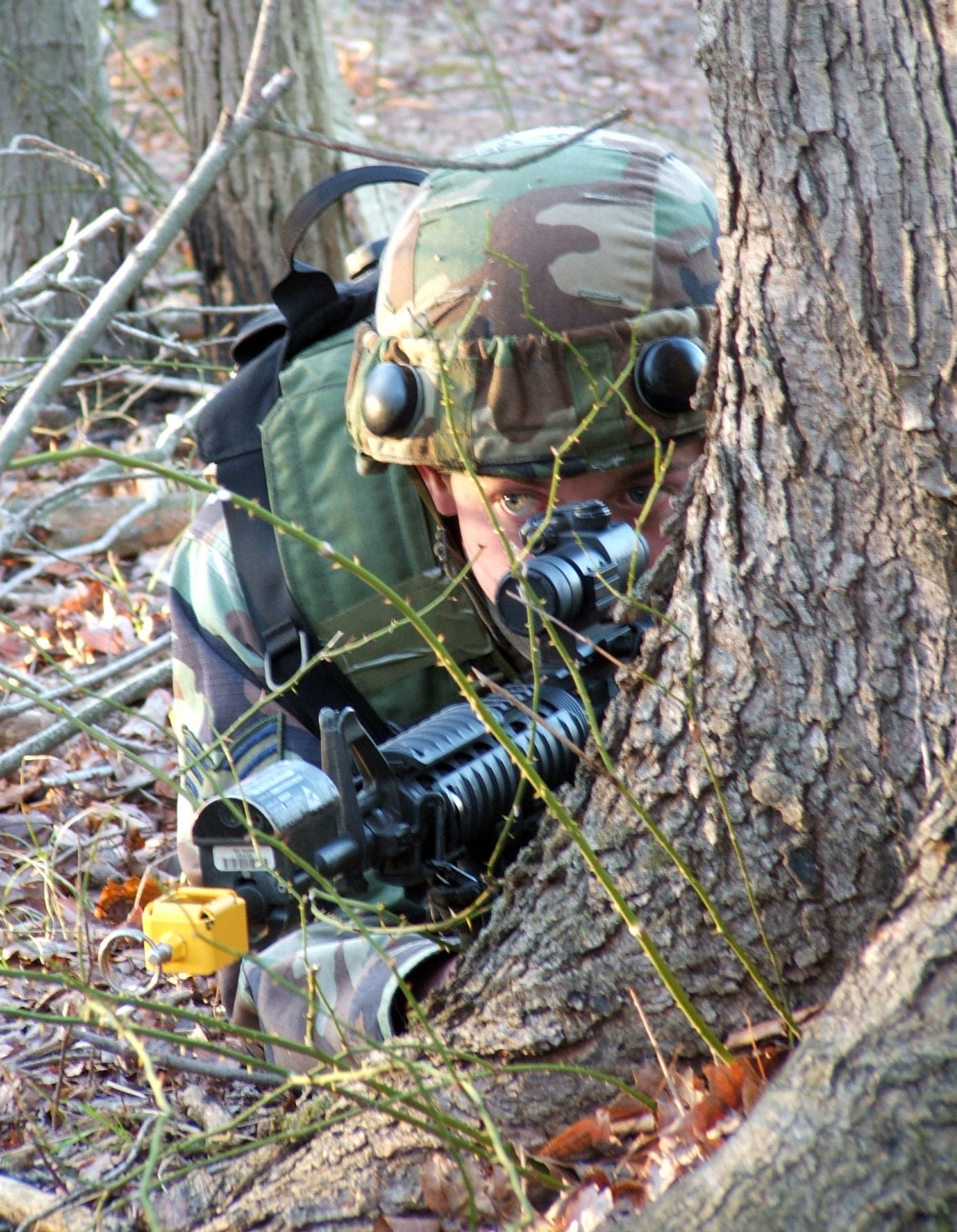 FORT DIX, N.J. (AFPN) -- An Airman participating in Air Force Integrated Contingency Skills Training Course 06-1 here takes up a position in the woods during a training session on combat patrol and tactics on a range. The CST course has more than 100 Airmen from multiple Air Force career fields participating and is taught by the Air Mobility Warfare Center's 421st Combat Training Squadron. The training teaches Airmen everything from combat tactics and patrolling to convoy operations and combat first aid. (U.S. Air Force photo by Tech. Sgt. Scott T. Sturkol)