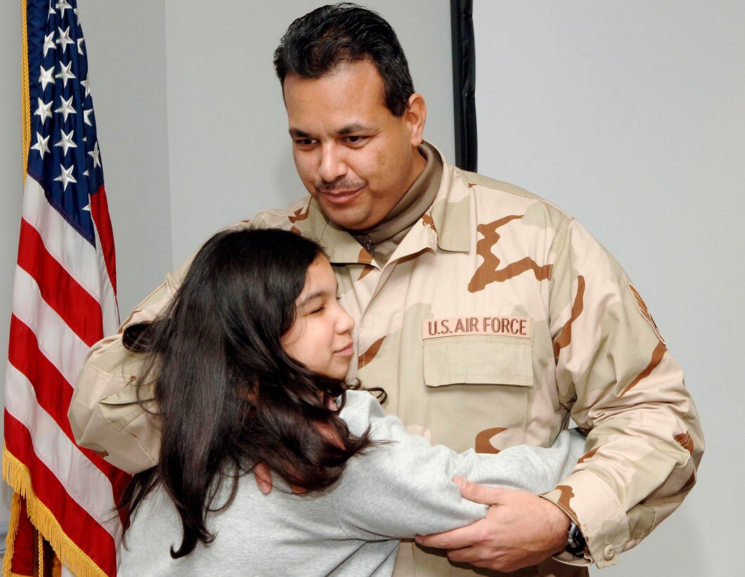 MCGUIRE AIR FORCE BASE, N.J. (AFPN) -- Staff Sergeant Edwin Tirado hugs his daughter, Ashley, during a farewell luncheon here Jan. 23. Sergeant Tirado is assigned to the 88th Aerial Port Squadron.  Fourteen Airmen from the 88th and 35th APS deployed to Afghanistan for 120 days. (U.S. Air Force photo by Denise Gould)

