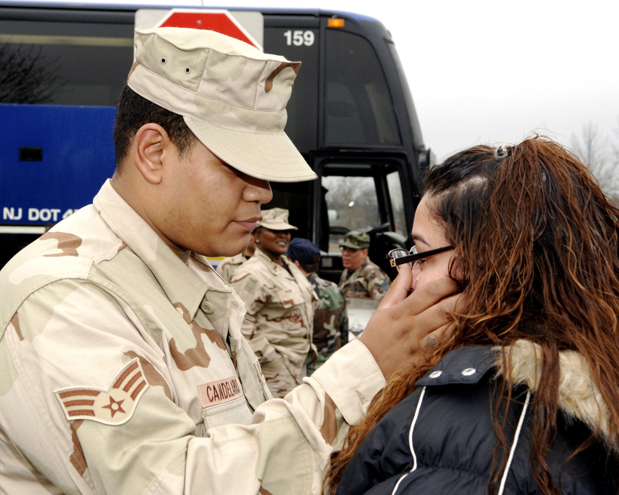 MCGUIRE AIR FORCE BASE, N.J. (AFPN) -- Senior Airman Isaac Candelario wipes tears from the face of his fiance, Jennifer Rivera, before deploying Jan. 23. Airman Candelario is assigned to the 88th Aerial Port Squadron here.  Fourteen Airmen from the 88th and 35th APS deployed to Afghanistan for 120 days. (U.S. Air Force photo by Denise Gould)

