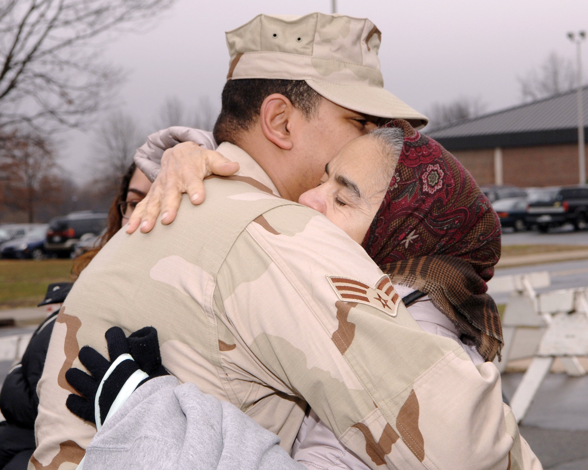 MCGUIRE AIR FORCE BASE, N.J. (AFPN) -- Senior Airman Isaac Candelario hugs his grandmother, Digna Medina, goodbye before deploying Jan. 23. Airman Candelario is assigned to the 88th Aerial Port Squadron here.  Fourteen Airmen from the 88th and 35th APS deployed to Afghanistan for 120 days. (U.S. Air Force photo by Denise Gould)

