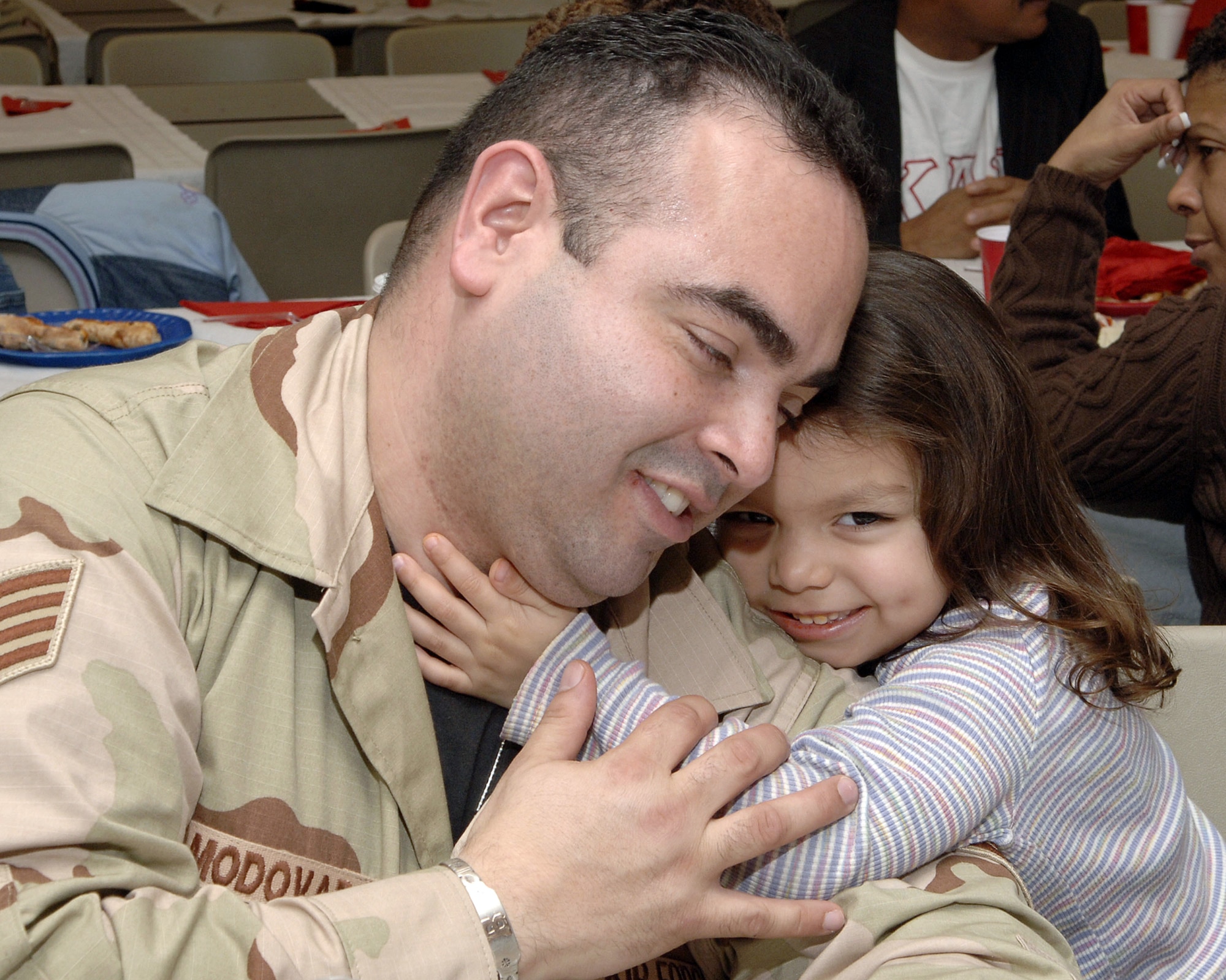 MCGUIRE AIR FORCE BASE, N.J. (AFPN) -- Staff Sgt. Benjamin Almodovar hugs his niece, Kaitlyn Tirado, during a farewell luncheon Jan. 23 before deploying. Sergeant Almodovar is assigned to the 88th Aerial Port Squadron here.  His niece is the daughter of Staff Sgt. Edwin Tirado, also assigned to the squadron. Fourteen Airmen from the 88th and 35th APS deployed to Afghanistan for 120 days. (U.S. Air Force photo by Denise Gould)

