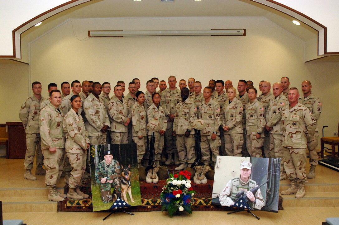 SOUTHWEST ASIA (AFPN) -- More that 200 people attended a memorial service at a deployed location in Southwest Asia for the two security forces Airmen killed in Iraq Jan. 22. In attendance were 40 other deployed members from Elmendorf Air Force Base, Alaska, home station of the fallen Airmen -- Tech. Sgt. Jason L. Norton and Staff Sgt. Brian McElroy. Joining members from the 379th Air Expeditionary Wing were British and Australian troops who came to pay their respects.  (U.S. Air Force photo by Staff Sgt. Joshua Strang)

