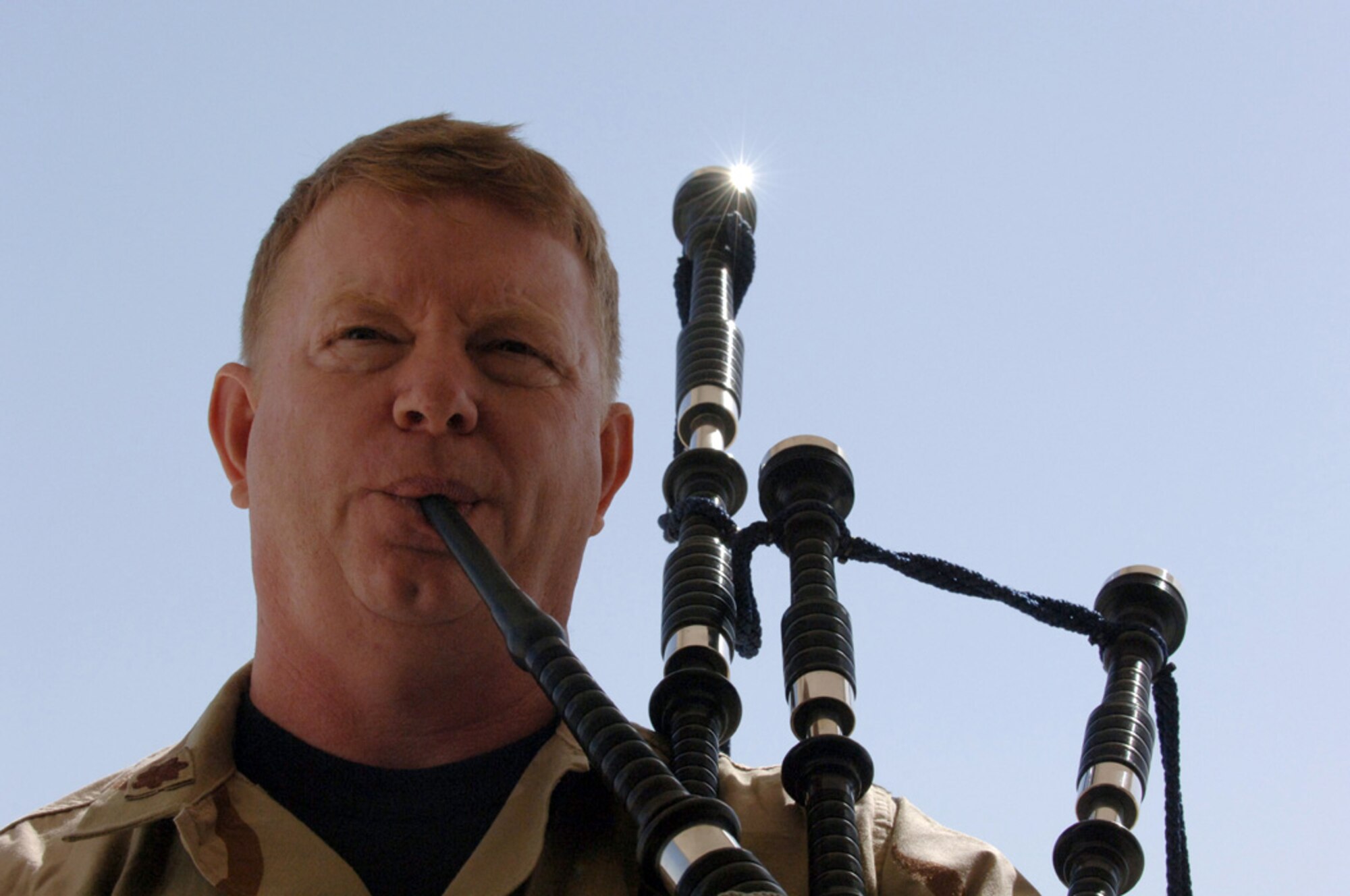 SOUTHWEST ASIA (AFPN) -- Chaplain (Maj.) Michael Gilbert plays bagpipes during a memorial service here Jan. 26 held in honor of two Elmendorf Air Force Base, Alaska, security forces Airmen killed in action. Major Gilbert is the chaplain for the 379th Air Expeditionary Wing.  (U.S. Air Force photo by Staff Sgt. Joshua Strang)


