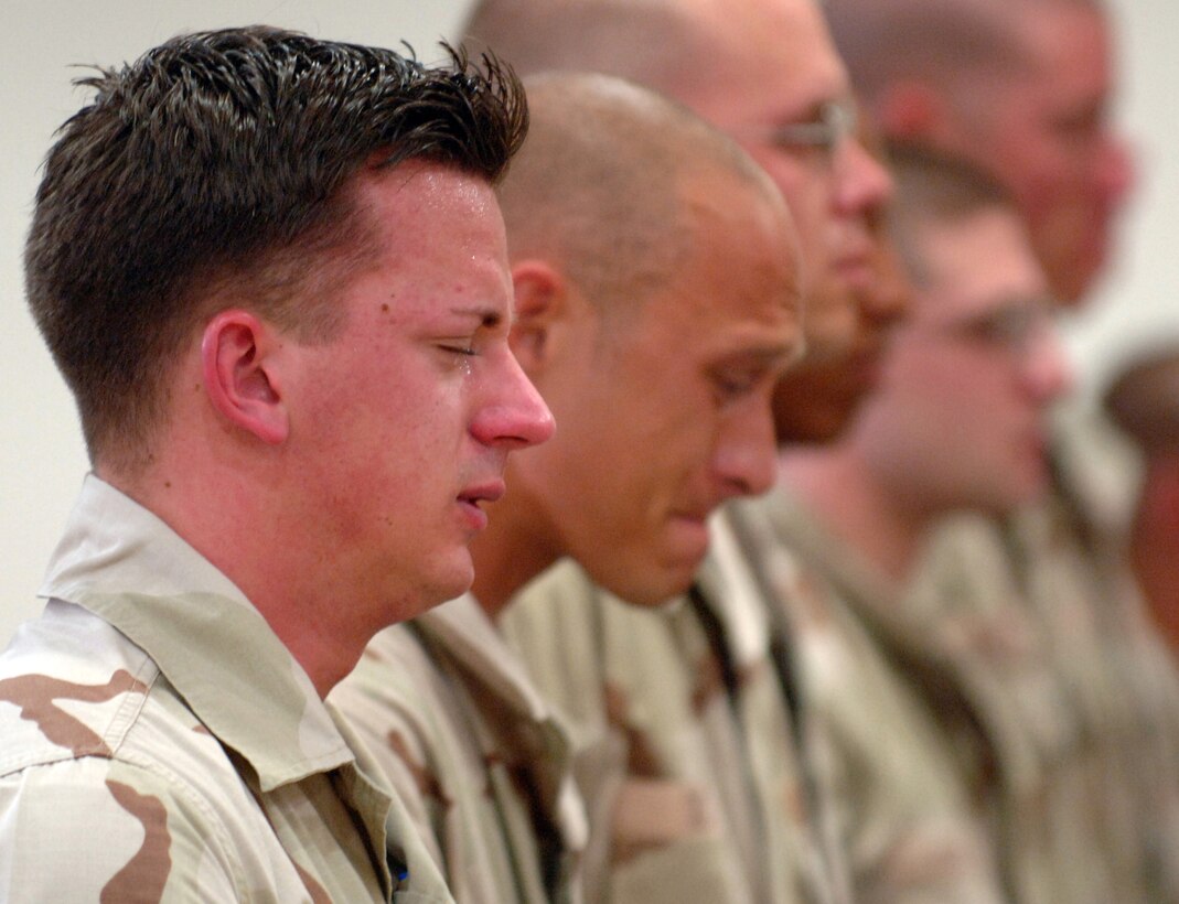 SOUTHWEST ASIA -- Airmen with the 379th Expeditionary Security Forces Squadron mourn the loss of two fellow security forces Airmen, Tech. Sgt. Jason L. Norton and Staff Sgt. Brian McElroy, killed in action Jan. 22 in Southwest Asia. (U.S. Air Force photo by Staff Sgt. Joshua Strang)
