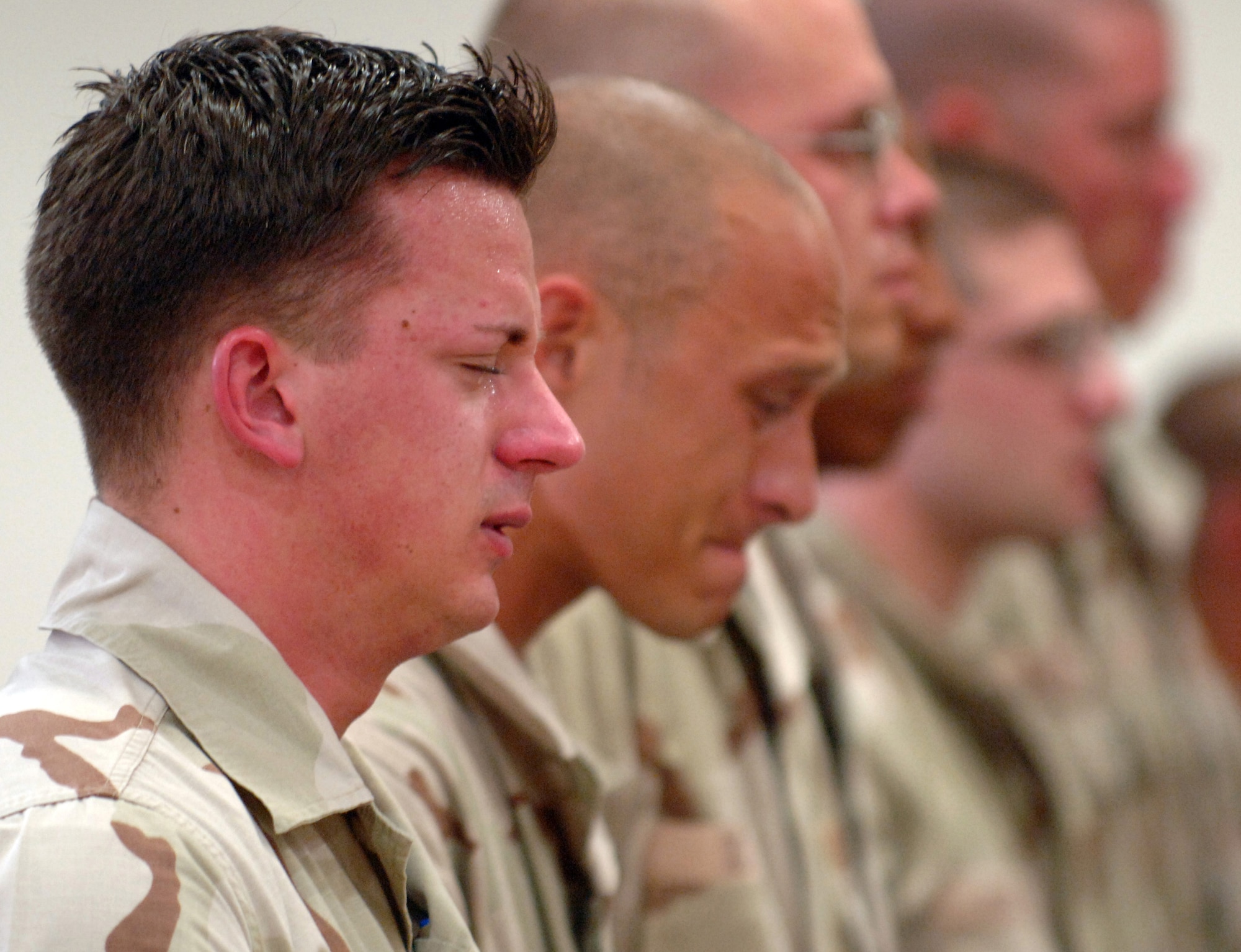 SOUTHWEST ASIA -- Airmen with the 379th Expeditionary Security Forces Squadron mourn the loss of two fellow security forces Airmen, Tech. Sgt. Jason L. Norton and Staff Sgt. Brian McElroy, killed in action Jan. 22 in Southwest Asia. (U.S. Air Force photo by Staff Sgt. Joshua Strang)

