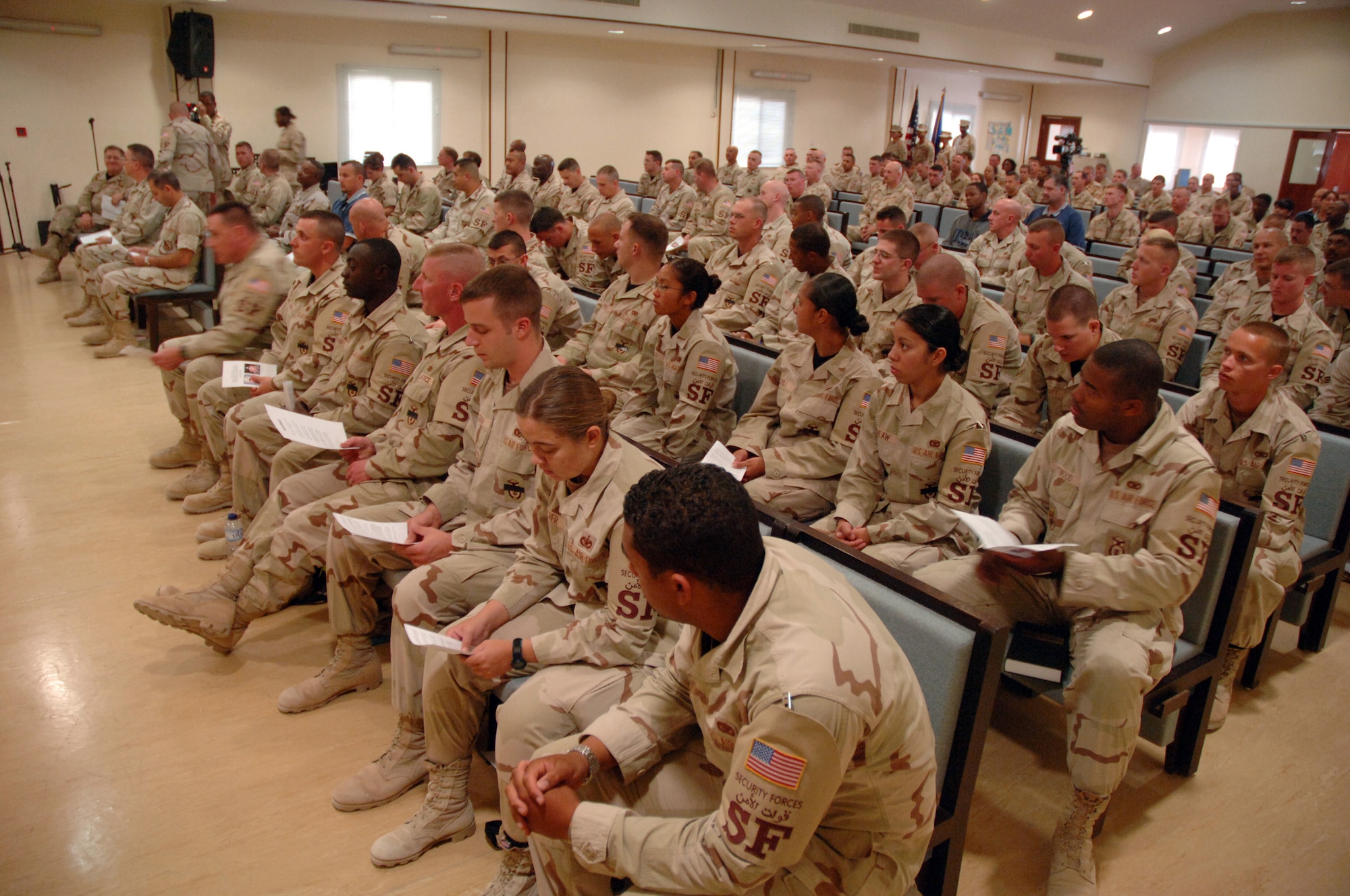 SOUTHWEST ASIA (AFPN) -- More than 200 people attended a memorial service at a deployed location in Southwest Asia for the two security forces Airmen killed in Iraq Jan. 22. In attendance were 40 other deployed members from Elmendorf Air Force Base, Alaska, home station of the fallen service members -- Tech. Sgt. Jason L. Norton and Staff Sgt. Brian McElroy. Joining Airmen from the 379th Air Expeditionary Wing were British and Australian troops who came to pay their respects. (U.S. Air Force photo by Staff Sgt. Joshua Strang)

