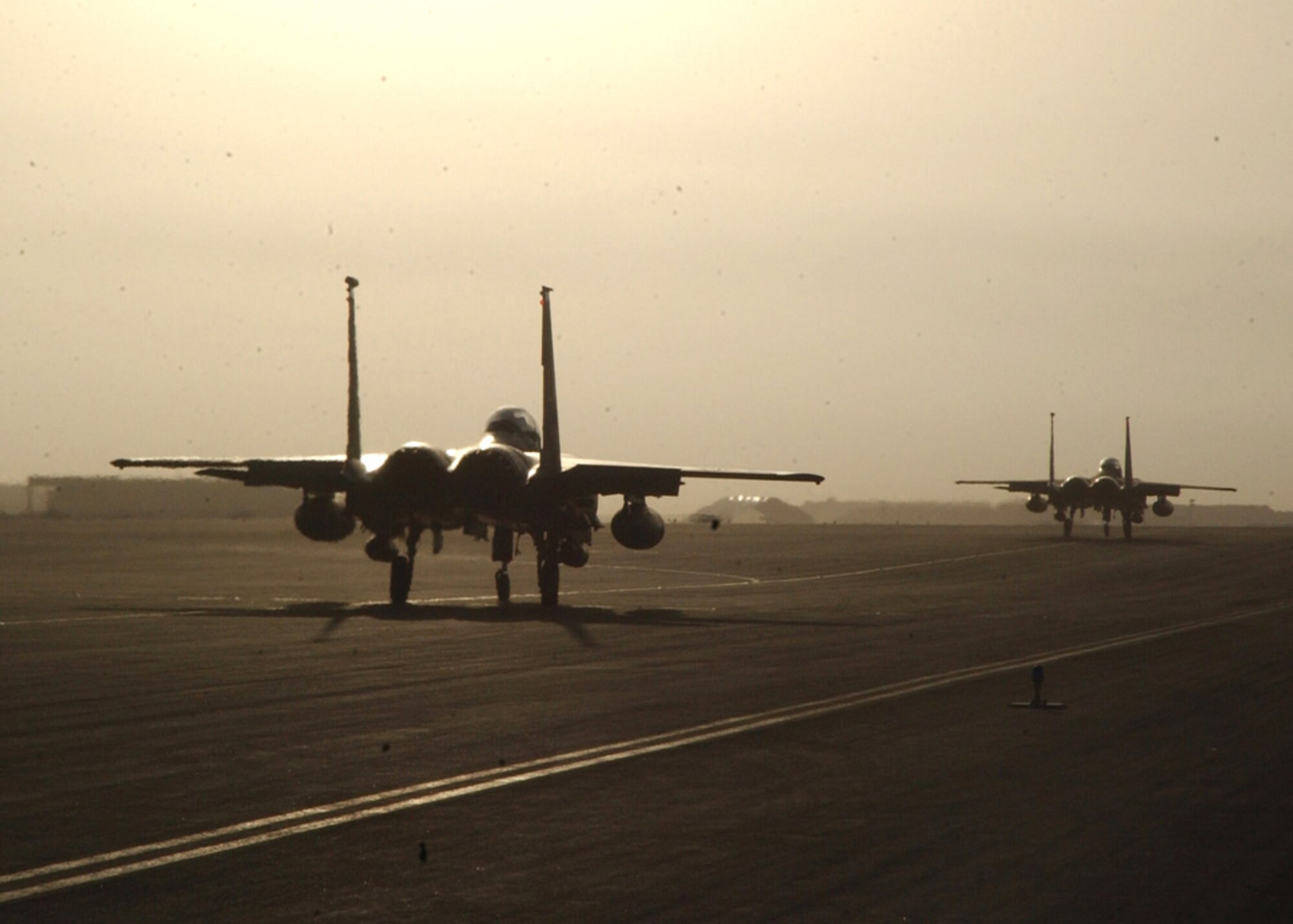 SOUTHWEST ASIA (AFPN) -- Two F-15E Strike Eagles taxi down the flightline here Jan. 25. The Strike Eagles were assigned to the 492nd Expeditionary Fighter Squadron.  The unit returned to its home station at Royal Air Force Lakenheath, England, Jan. 25.  (U.S. Air Force photo by Airman 1st Class Anthony Nelson Jr.)


