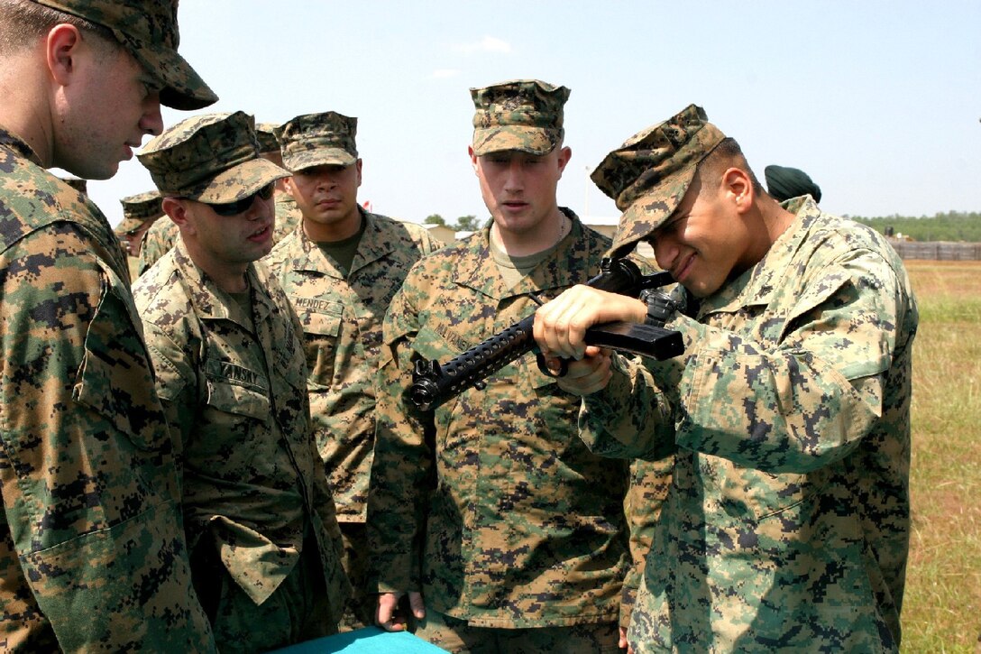 BELGUAM, India (Oct. 26, 2006) -- Marines with Echo Co., Battalion Landing Team 2/4, mess around with a 9MM Carbine in order to familiarize themselves with Indian weapons and tactics during Exercise Shatrujeet 06.