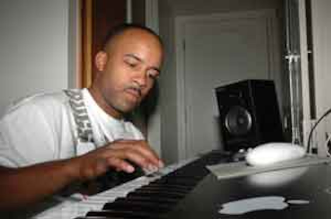 Sgt. Harlan C. Black, Marine Aviation Control Squadron 1 air traffic controller, mixes music beats on his studio system in his barracks room June 26. Black used the money he earned while deployed in Iraq to finance a system that allows him to mix, edit and produce his music.