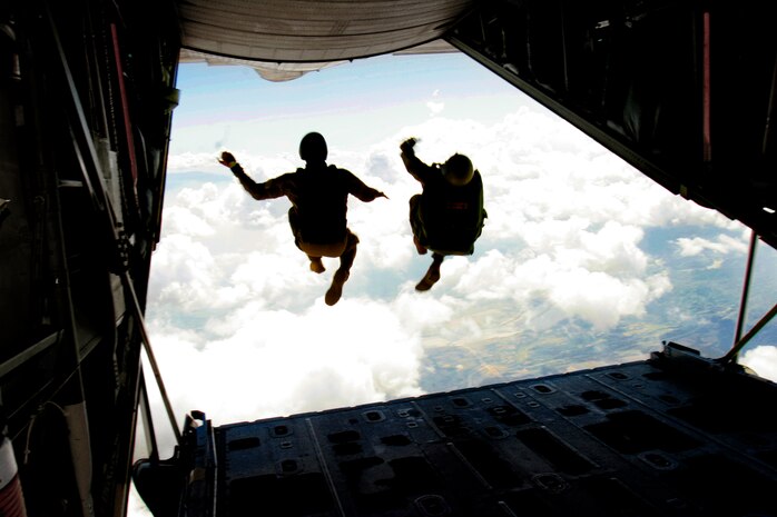 CLARK AIR BASE, Philippines â?? U.S. Marine Master Sgt. Daniel P. Furiak and Peter Strinden perform jump together out of a U.S. Marine Corps KC-130 Hercules aircraft during a High Altitude-Low Opening jump Feb. 27 as part of Exercise Balikatan 2006. HALO is a tactical jumping technique in which the parachutist opens their parachute at a low altitude after free-falling for a period of time. Furiak is the paraloft chief for 3rd Reconnaissance Battalion, 3rd Marine Division. Strinden is the parachutes project officer for Marine Corps Systems Command.