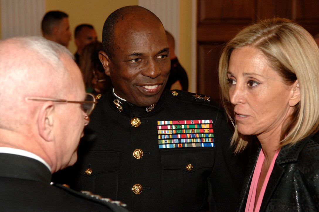 General Robert Magnus, assistant commandant of the Marine Corps, and Maj. Gen. Walter Gaskin, commanding general Marine Corps Recruiting Command, talk with Angela Zavala, editor, Hispanic Yearbook, during a reception at the Library of Congress April 27.  The reception was held to celebrate the release of the 2006 Hispanic Yearbook.  The 400-page book includes information about prominent Hispanic individuals, organizations, businesses and media outlets, along with a five-page advertorial highlighting past and present achievements of Hispanics in the Marine Corps.