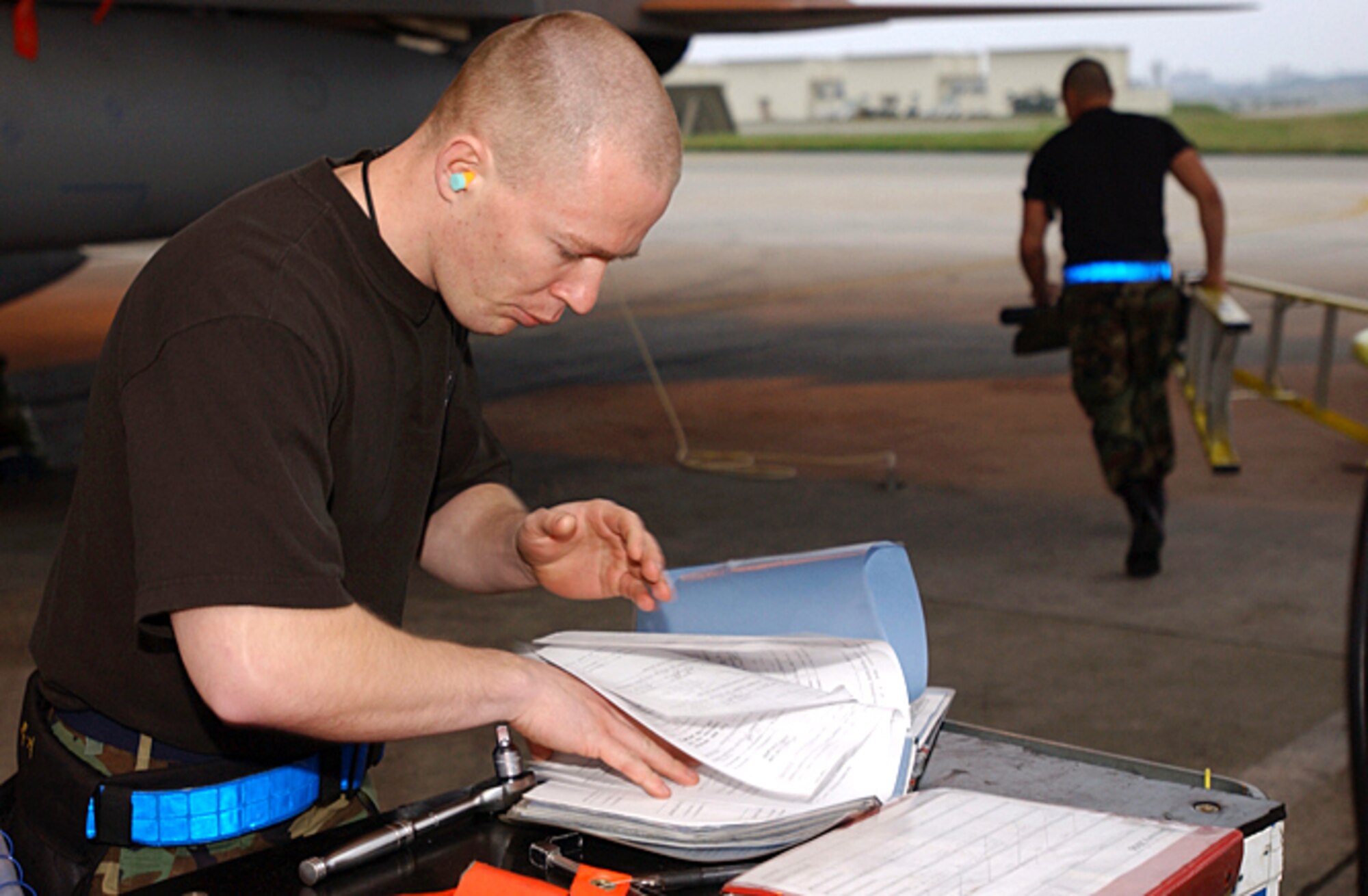 KADENA AIR BASE, Japan (AFPN) -- Staff Sgt. Matthew Andrews reads through a checklist before he begins loading munitions. Airmen competed in a load crew competition Jan. 27. The load crew competition evaluates the Airmen's timeliness and accuracy of loading munitions. (U.S. Air Force photo by Airman 1st Class Stephanie Sinclair)