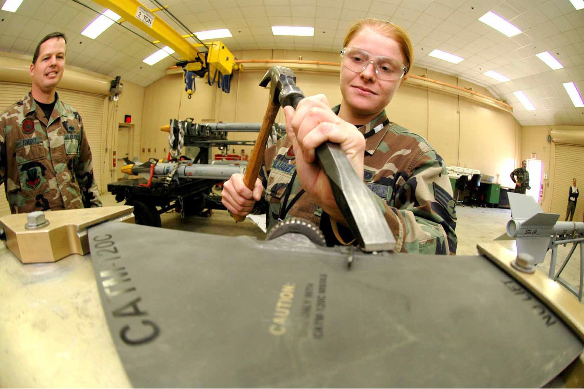 EGLIN AIR FORCE BASE, Fla. (AFPN) -- Senior Airman Theresa Velasquez removes a rivet on an AIM-120 fin using a fixture created by the munitions materiel handling equipment focal point here. Before the crew had this piece of equipment it could not change the locks and had to send the fin off for a depot-level repair. This process would have taken at least a month and now it is done within minutes inside the shop. Airman Velasquez is a precision-guided munitions crewmember assigned to the 33rd Maintenance Squadron. (U.S. Air Force photo by Senior Airman Mike Meares)