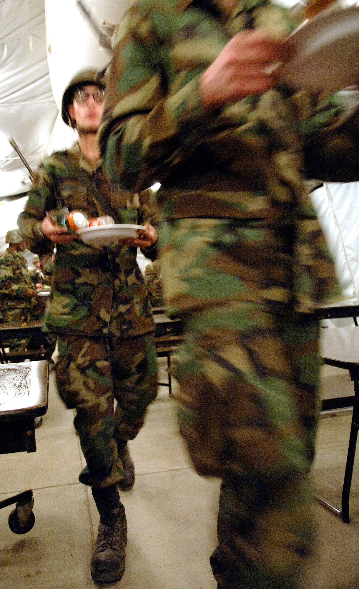 LACKLAND AIR FORCE BASE, Texas (AFPN) -- Trainees in the warrior week portion of basic military training march to a table to eat lunch.  The meal was prepared by Airmen attending the services apprentice course here. The 31-day course consists of teaching all facets of the services technical trade. (U.S. Air Force photo by Tech. Sgt. Larry A. Simmons)


