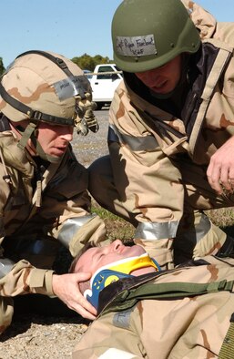 Master Sgt. Tom Rago and Capt. Ryan Freeland, 16th Operations Support Squadron, perform self aid and buddy care on a simulated downed Airman who was ran over by a forklift.  (U.S. Air Force Photo by Airman 1st Class Ali Flisek)                