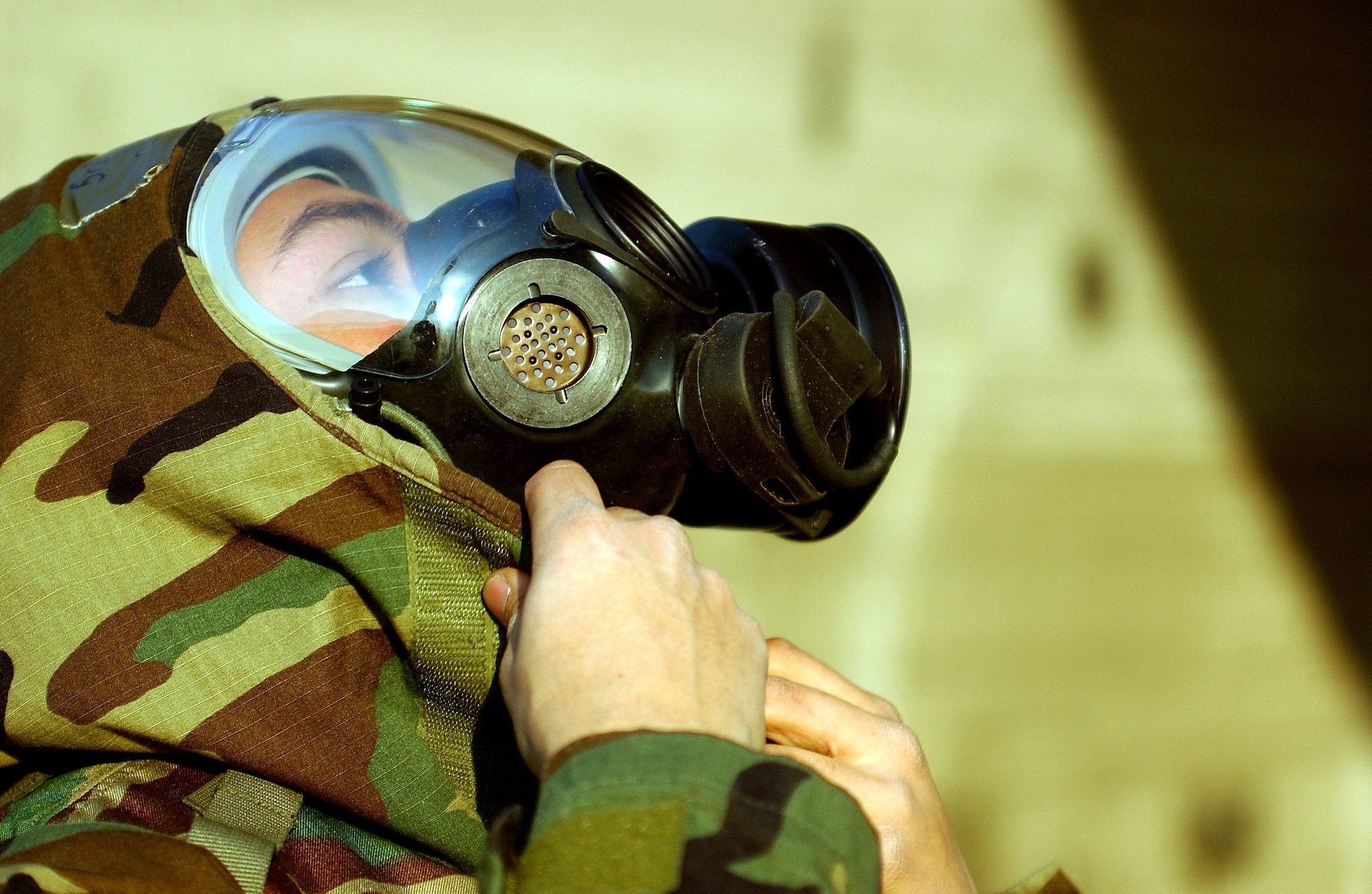 OSAN AIR BASE, South Korea (AFPN) -- Senior Airman Josue Mendo dons his chemical defense gear during exercise Beverly Bulldog 06-01 here Jan. 24. Exercise scenarios test the base's ability to protect its operations from attacks or enemy forces. Airman Mendo is with the 51st Munitions Squadron. (U.S. Air Force photo by Airman Gina Chiaverotti) 

 

