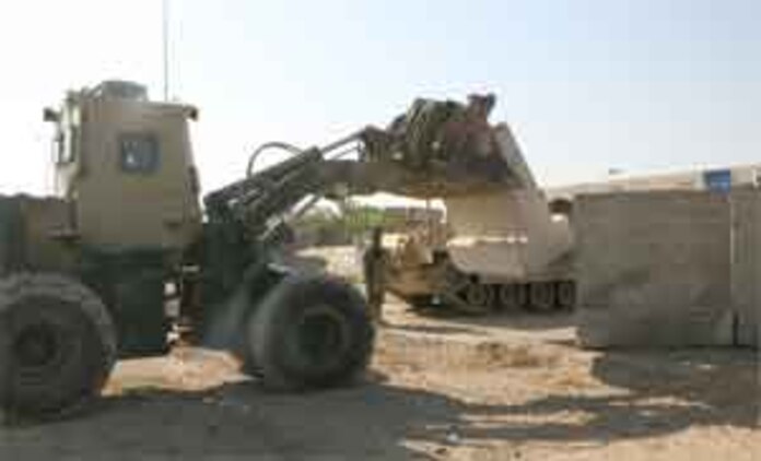 Marines and soldiers at Combat Outpost Falcon utilized up-armored forklifts, commonly referred to as a TRAM, to emplace over 300 concrete barriers June 26, 2006. The five Marines, a part of Combat Logistics Detachment 115, Combat Logistics Regiment 15, out of Camp Taqaddum, Iraq, aided the Army's 1st Brigade, 1st Armored Division in securing the combat outpost, a part of increased security operations in Southern Ramadi.