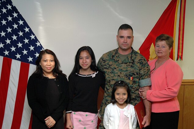INDIAN HEAD, Md.--Staff Sgt. Carson B. Jeffers stands with his wife (left to right) Sengchita, two daughters, Carrisa and Cindy and mother, Cynthia G. Jeffers following an award ceremony at the Chemical Biological Incident Response Force (CBIRF) June 16.  During the ceremony Jeffers, a native of Montgomery, Ala., was awarded the Navy and Marine Corps Medal; the highest peacetime award for heroism.  During and following the ceremony Carissa, 12, cried tears of joy.  "I was so happy I couldn't smile," said Carissa.  "People finally noticed that he [my father] is a hero.  So many people are heroes but they don't get noticed."