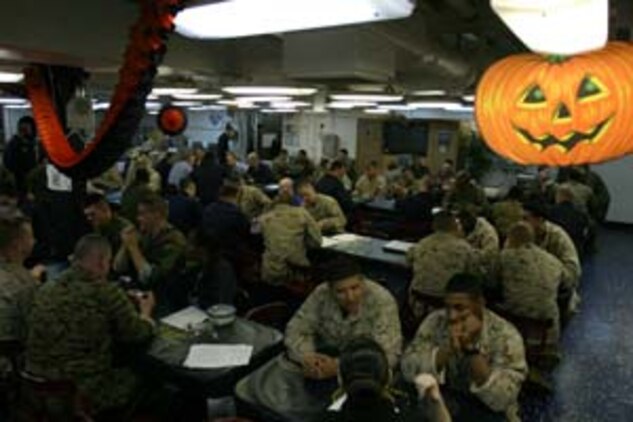Marines and Sailors aboard USS Bataan (LHD-5) participate in a Texas Hold 'em tournament, October 28, 2006. The tournament was held by the Moral, Welfare, and Recreation office during the 26th Marine Expeditionary Unit's Composite Training Unit Exercise with the Bataan Strike Group, Oct. 24 to Nov. 7, 2006.