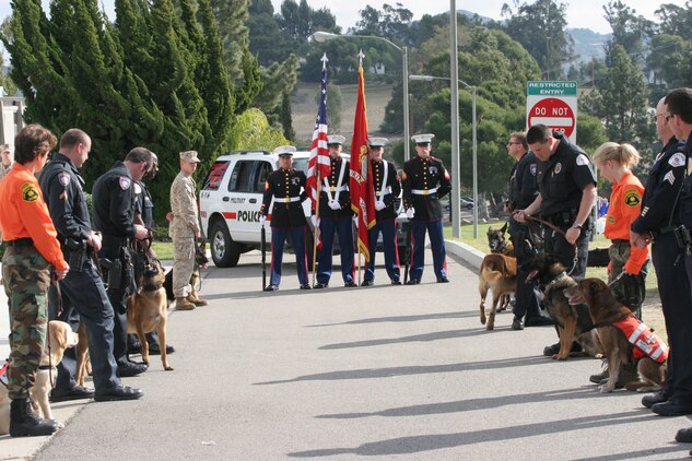 060127-M-7082F-002 CAMP PENDLETON, Calif. -- The Security Battalion Color Guard is flanked by K-9 handlers from the local Police Departments who have come to pay their respects to Sgt. Adam Cann at his memorial service here Jan. 27. Cann, from Destin, Fla., was killed in action Jan. 5 while conducting crowd control with his dog Bruno during his second deployment to Iraq. (Official U.S. Marine Corps photo by Lance Cpl. Patrick J. Floto)(released)