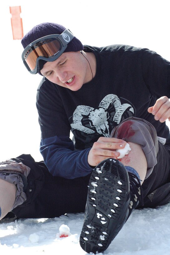 Cpl. Nate Lantz, Marine Aviation Logistics Squadron 13, known on the slopes as ?Nasty Nate?, checks a gash on his shin after biffing on a box in the freestyle park at Bear Mountain Jan. 28. The nurses patched him up and he was back on top of the mountain in no time.
