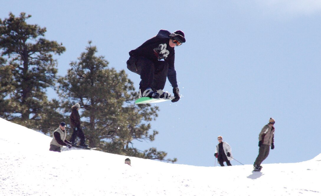 Cpl. Nate Lantz, Marine Aviation Logistics Squadron 13, grabs the outside rail of his snowboard Jan. 28 while about five feet above the slopes of Bear Mountain in Big Bear Lake, Calif. Lantz and other station service members hit the snow with the help of the Single Marine Program. The Big bear trip is an annual SMP event.