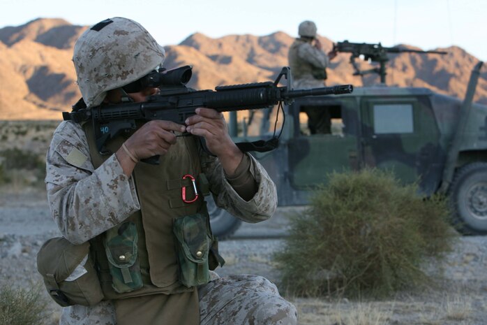 Pfc. Davis T. Aguila, motor transport operator, Headquaters and Service Company, 3rd Battalion, 8th Marine Regiment, provides security away from his vehicle during the Convoy Operations Course Jan. 30. The exercise is designed to enhance the skills of Marines and Sailors in convoy maveuvers and readiness.